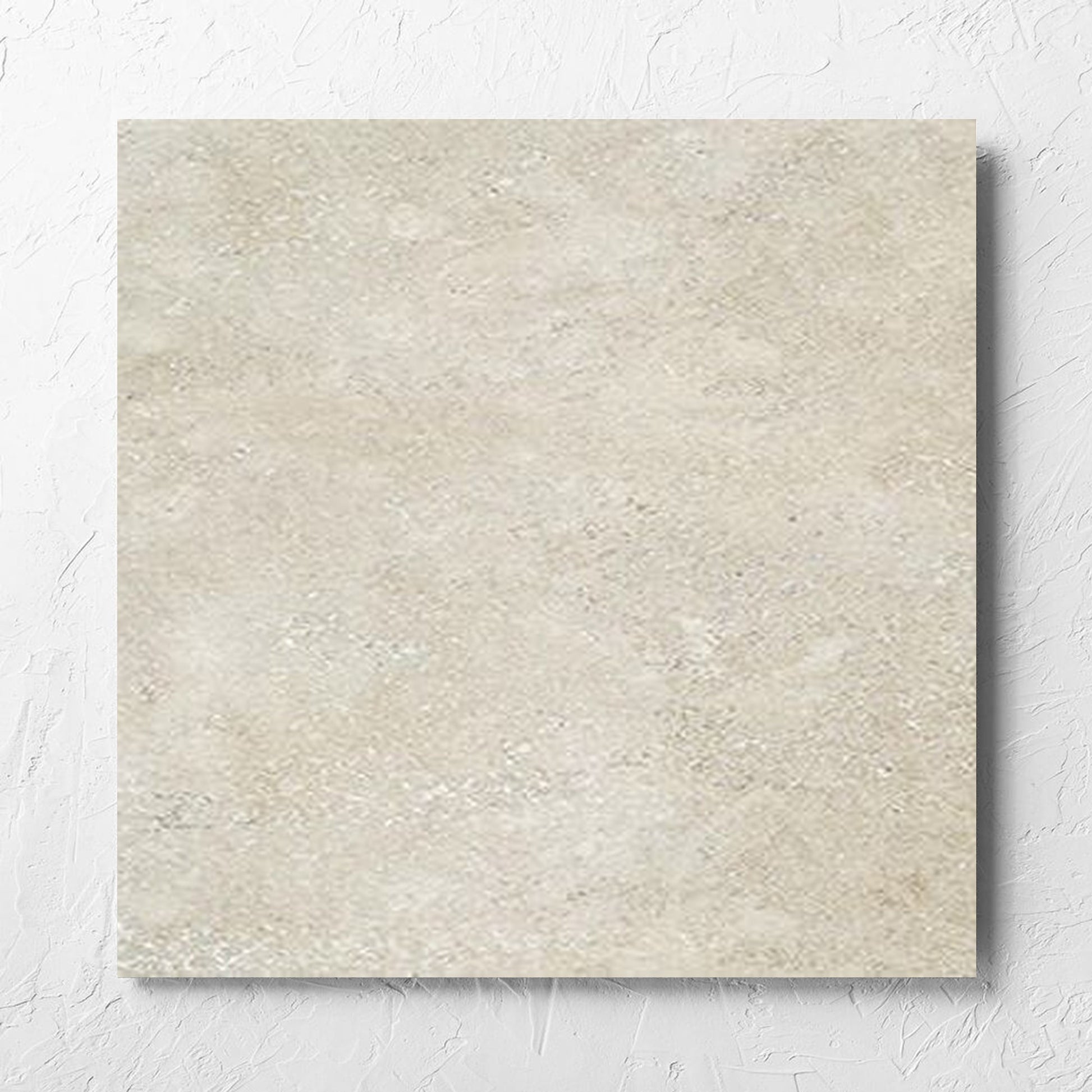 Stella Beige Lappato 600x600mm tile laid flat on a white rendered wall, showing the beige lappato surface