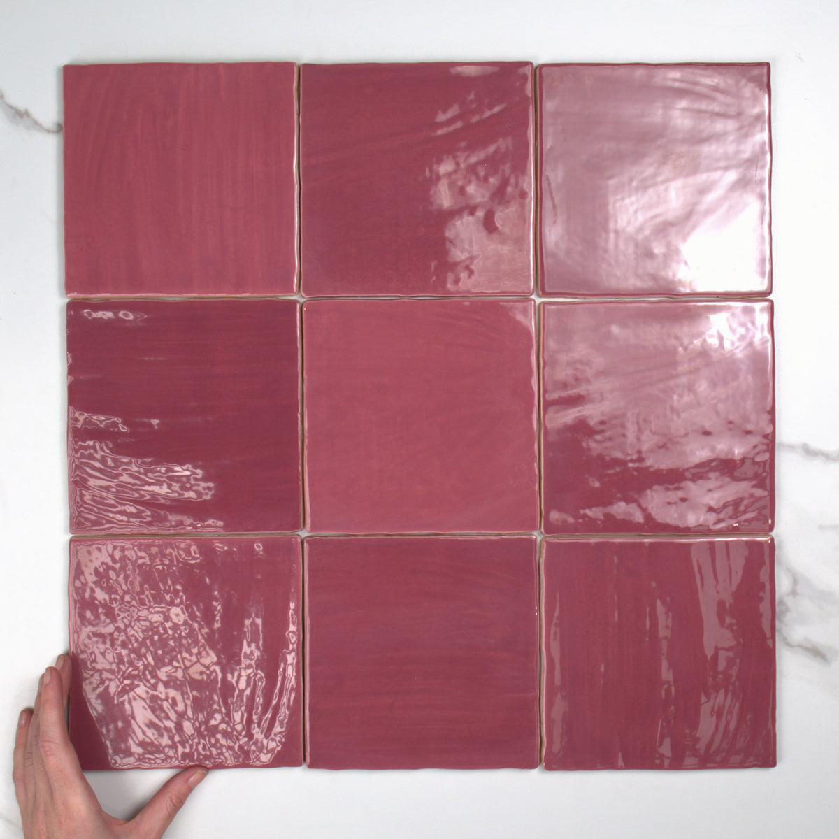 Tabarca Granate Gloss 150x150mm top view, hand for scale