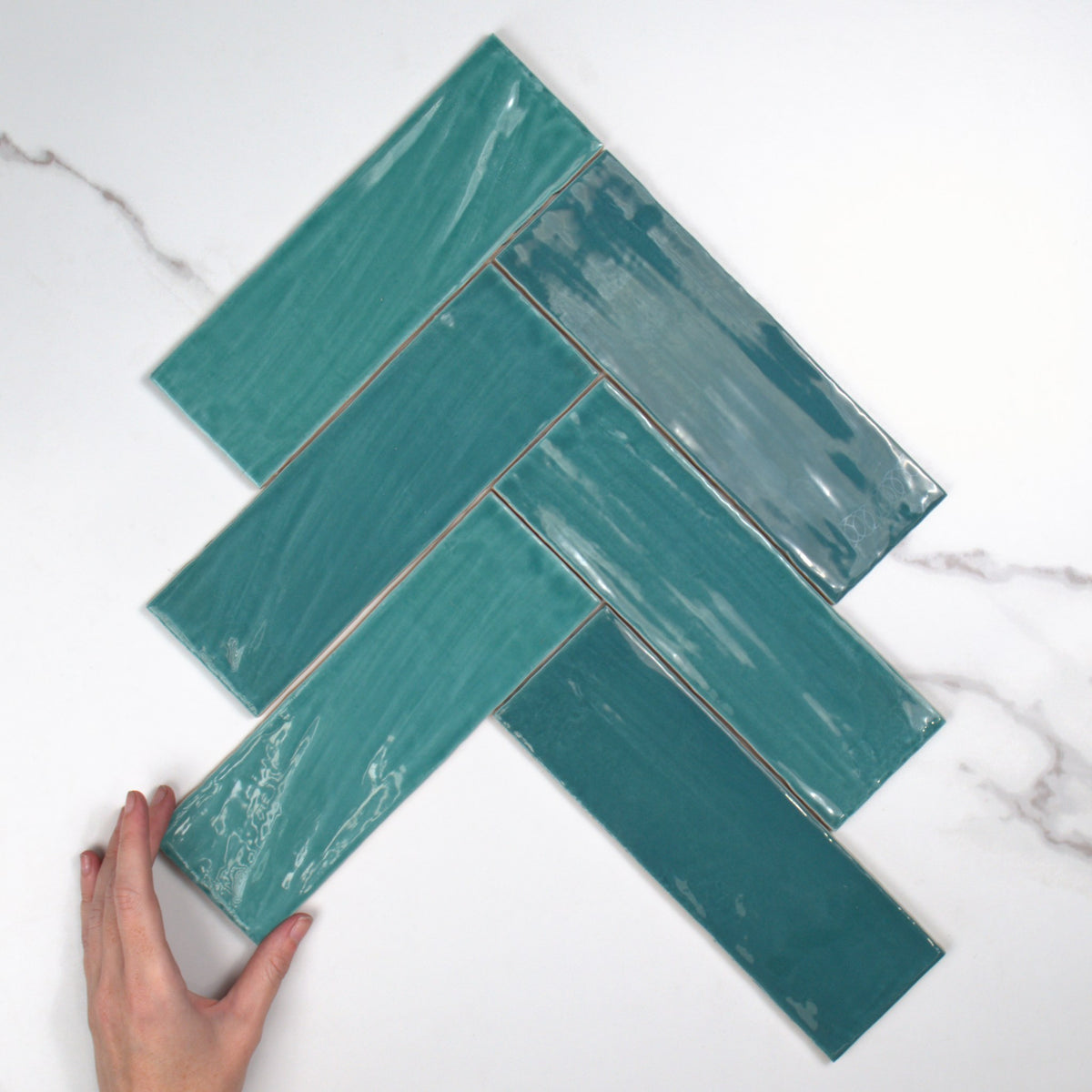 Tabarca Turquesa Gloss 75x230mm top view, hand for scale