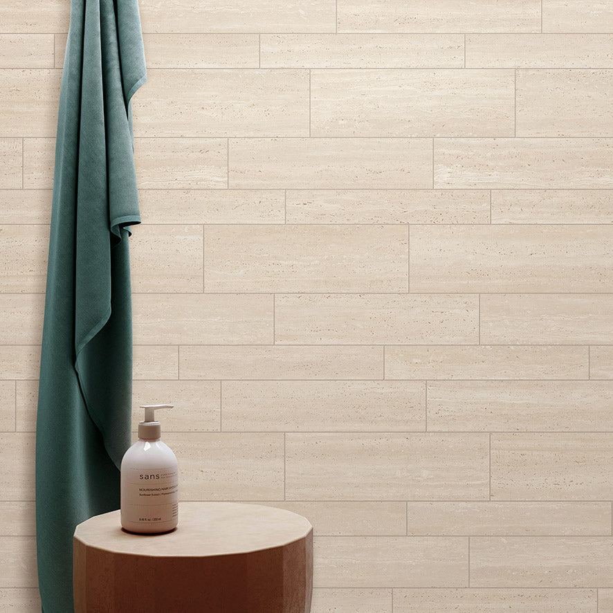 Tallow Vein Cut Travertine Look Beige 300x600mm tiles brick-laid on a bathroom wall