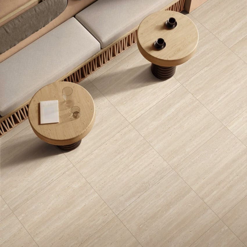 Tallow Vein Cut Travertine Look Beige travertine look tiles on a living room floor with sofa, overhead view