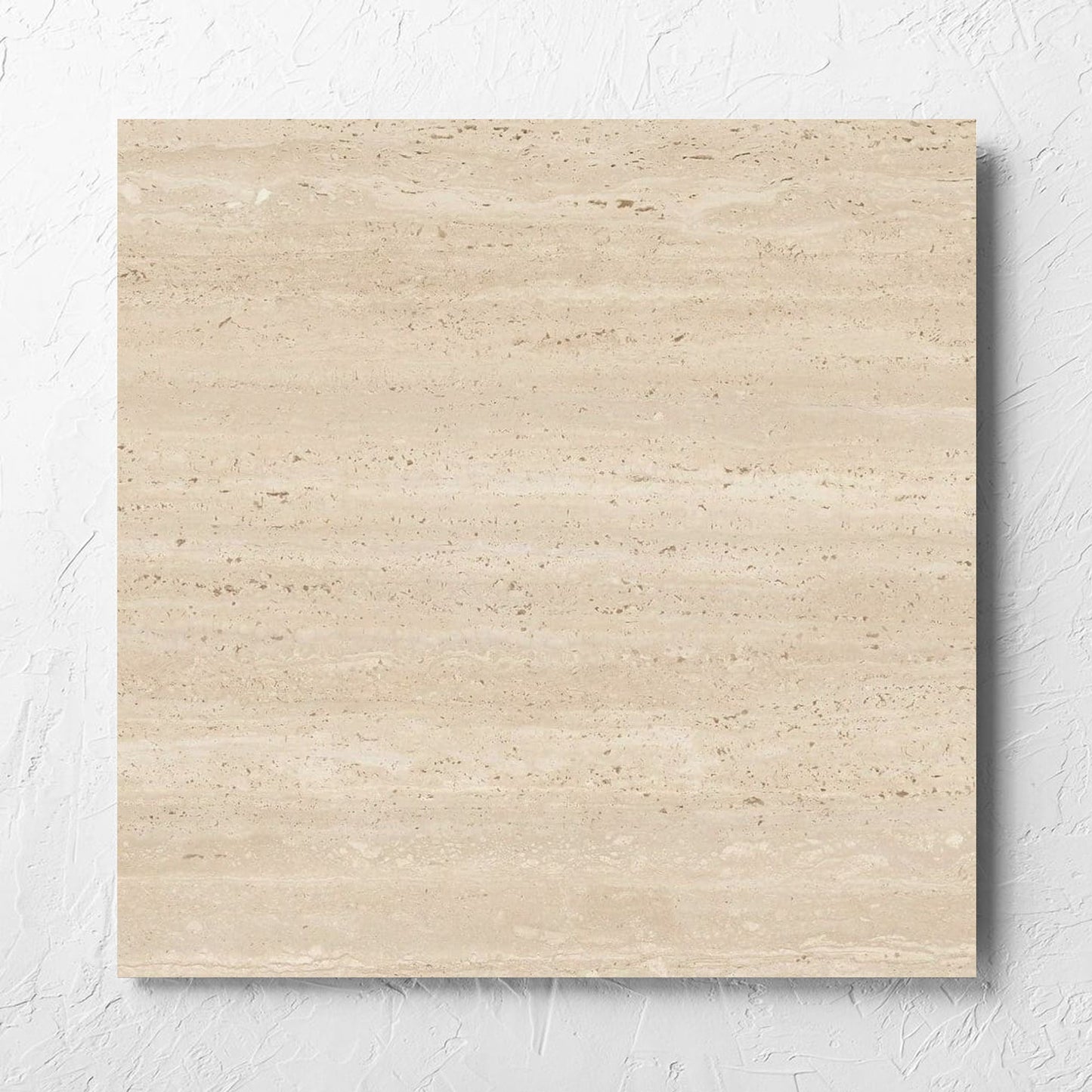 Tallow Vein Cut Travertine Look Beige 600x600mm tile laid flat on a white rendered wall, showing the beige matt surface