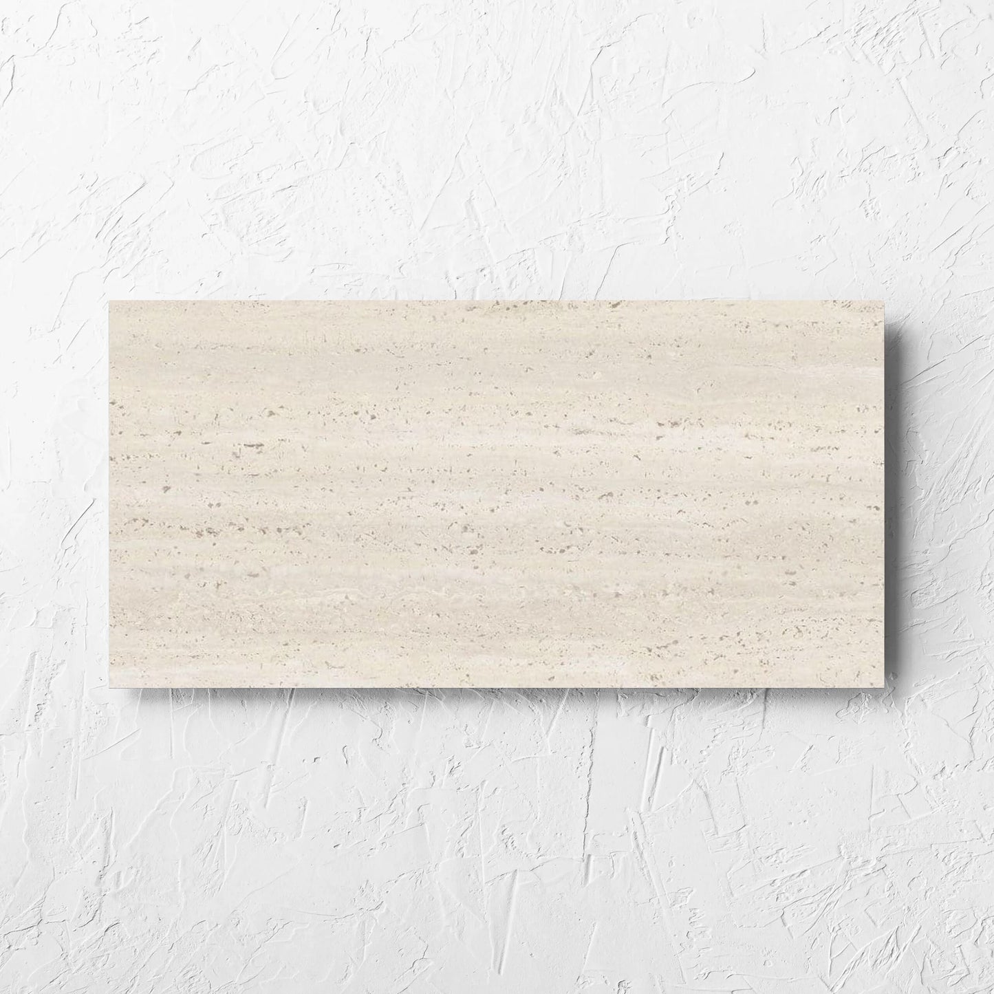 Tallow Vein Cut Travertine Look Ivory 300x600mm tile laid flat on a white rendered wall, showing the tile surface
