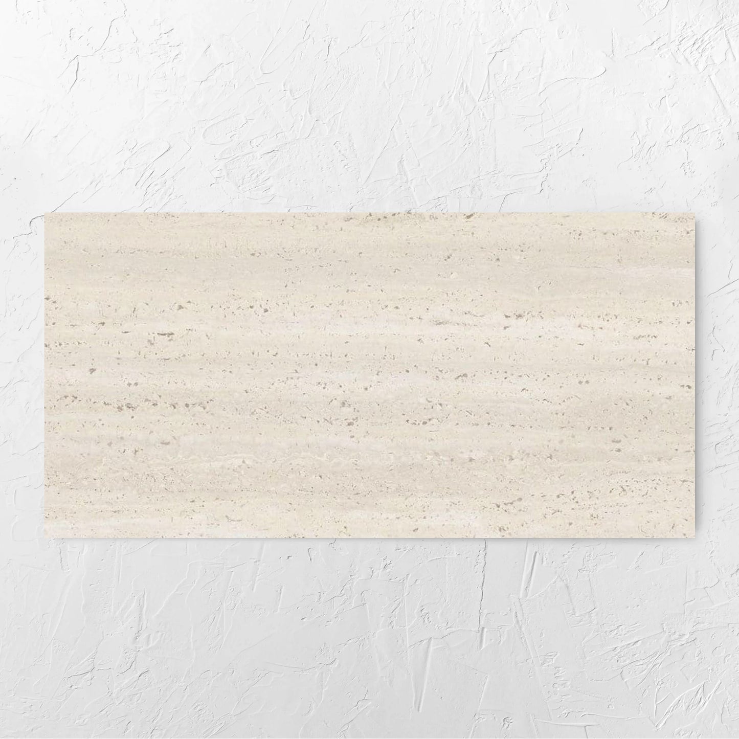 Tallow Vein Cut Travertine Look Ivory 600x1200mm tile laid flat on a white rendered wall, showing the beige matt surface