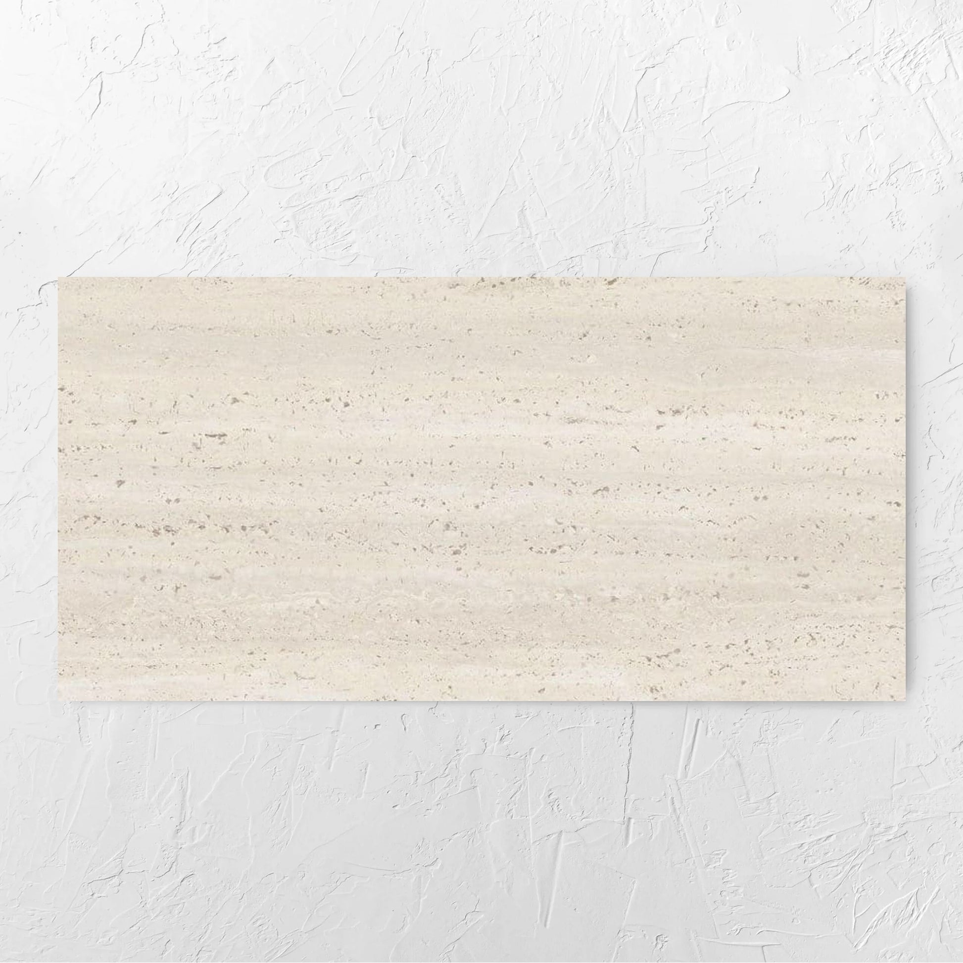Tallow Vein Cut Travertine Look Ivory 600x1200mm tile laid flat on a white rendered wall, showing the beige matt surface