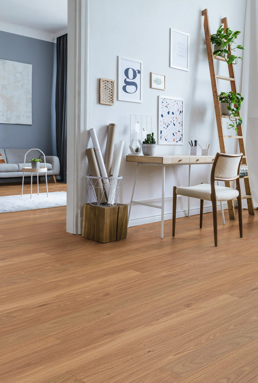 Tallowood Engineered Australian Classic Flooring 14/3mm installed in a bright Scandinavian-style home office with a timber desk, decorative ladder, and gallery wall.
