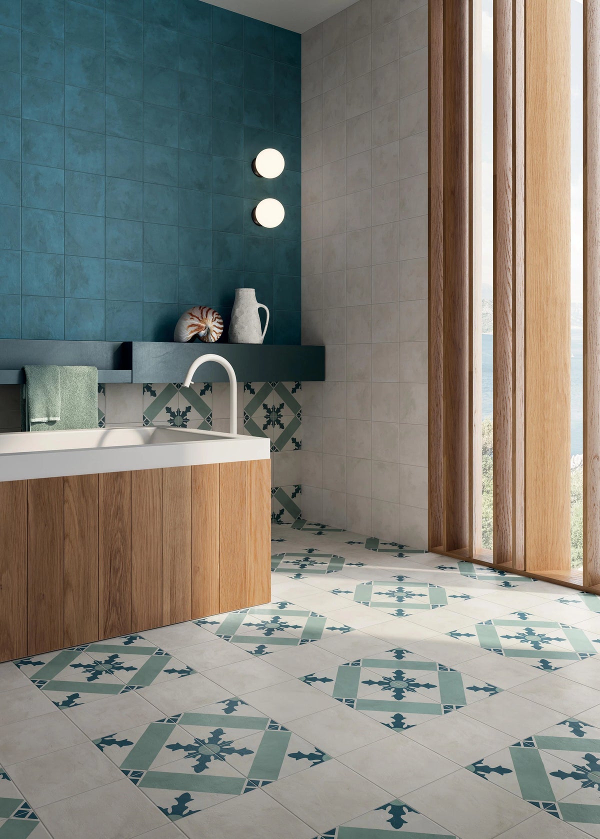 Terra Art Cardinale Oceano & Cielo 200x200mm patterned floor tiles in a modern bathroom with teal wall tiles, wooden vanity, and floor-to-ceiling windows.