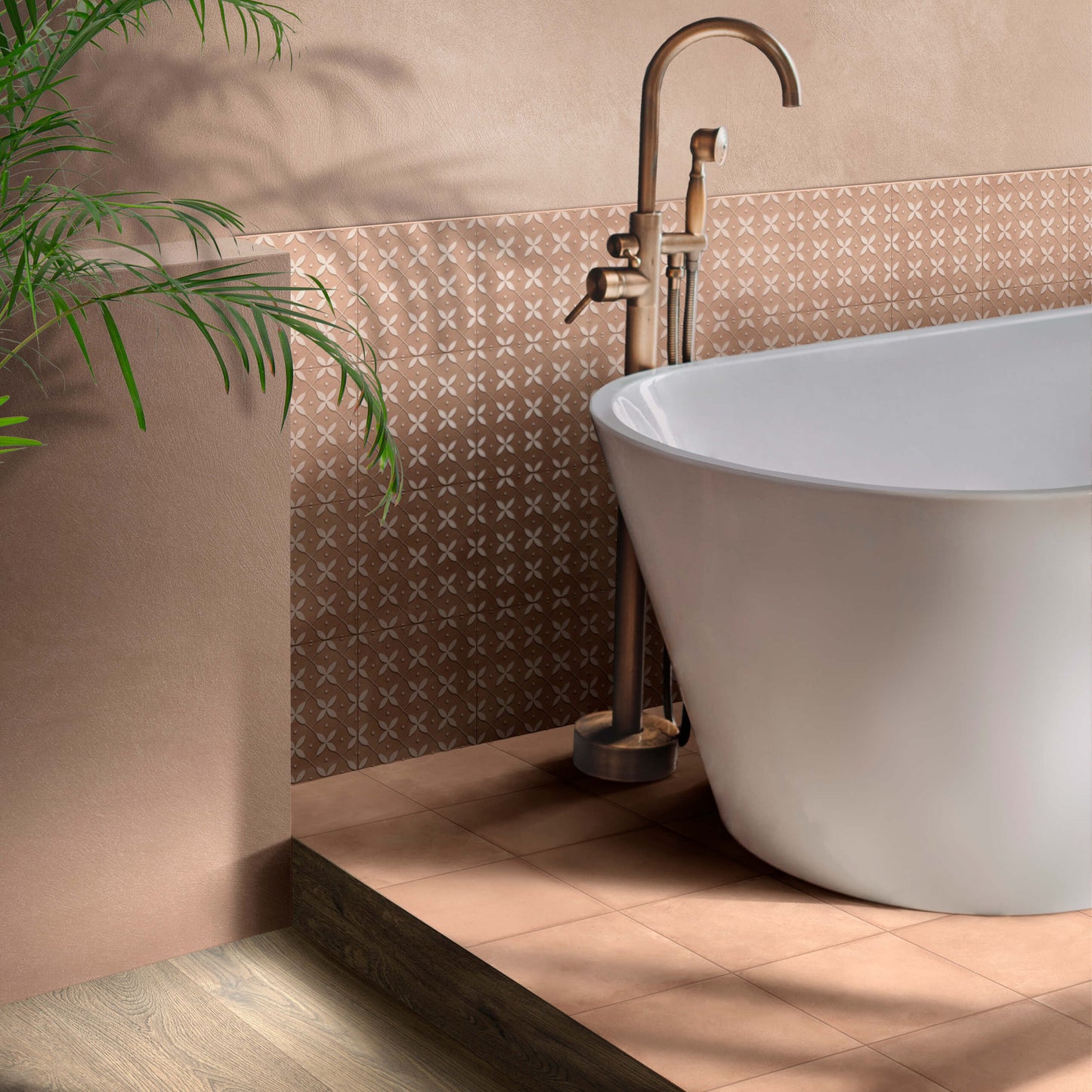 Terracota Cotto 200X200mm patterned tiles in warm terracotta tones installed as a feature wall behind a white freestanding bathtub with a brass floor-mounted faucet.