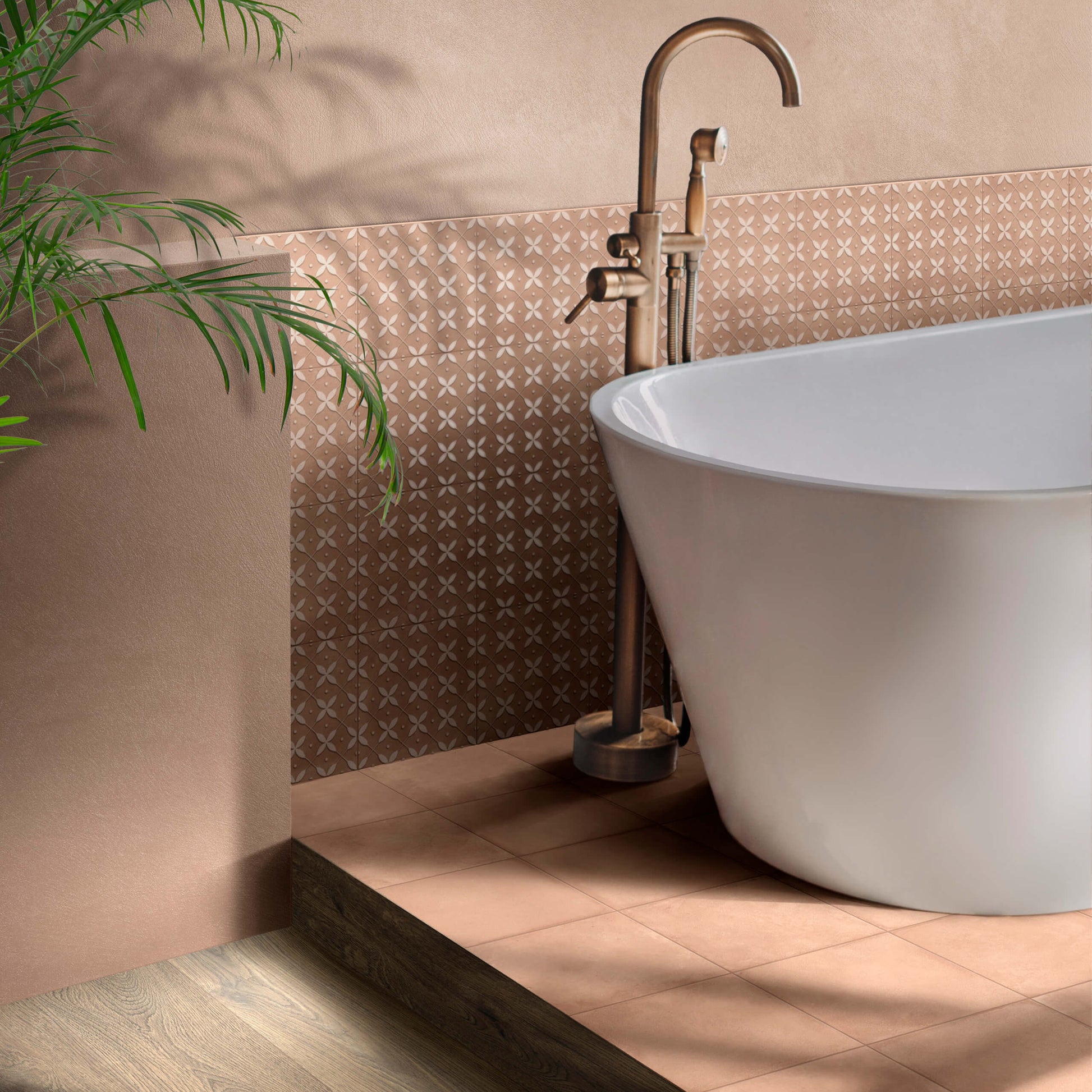 Terracota Cotto 200X200mm patterned tiles in warm terracotta tones installed as a feature wall behind a white freestanding bathtub with a brass floor-mounted faucet.