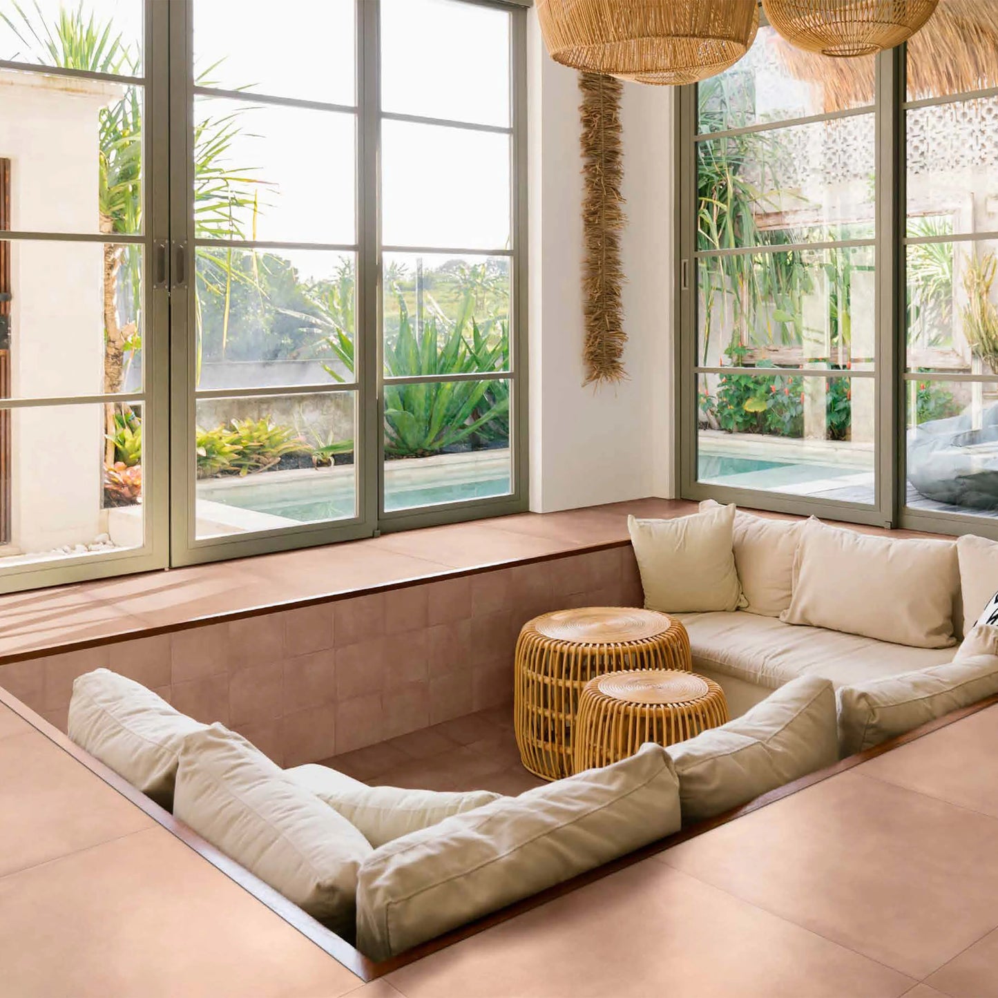 Terracota Cotto 200X200mm tiles lining a sunken living room lounge with cream cushions, rattan pendant lights, and tropical garden views.