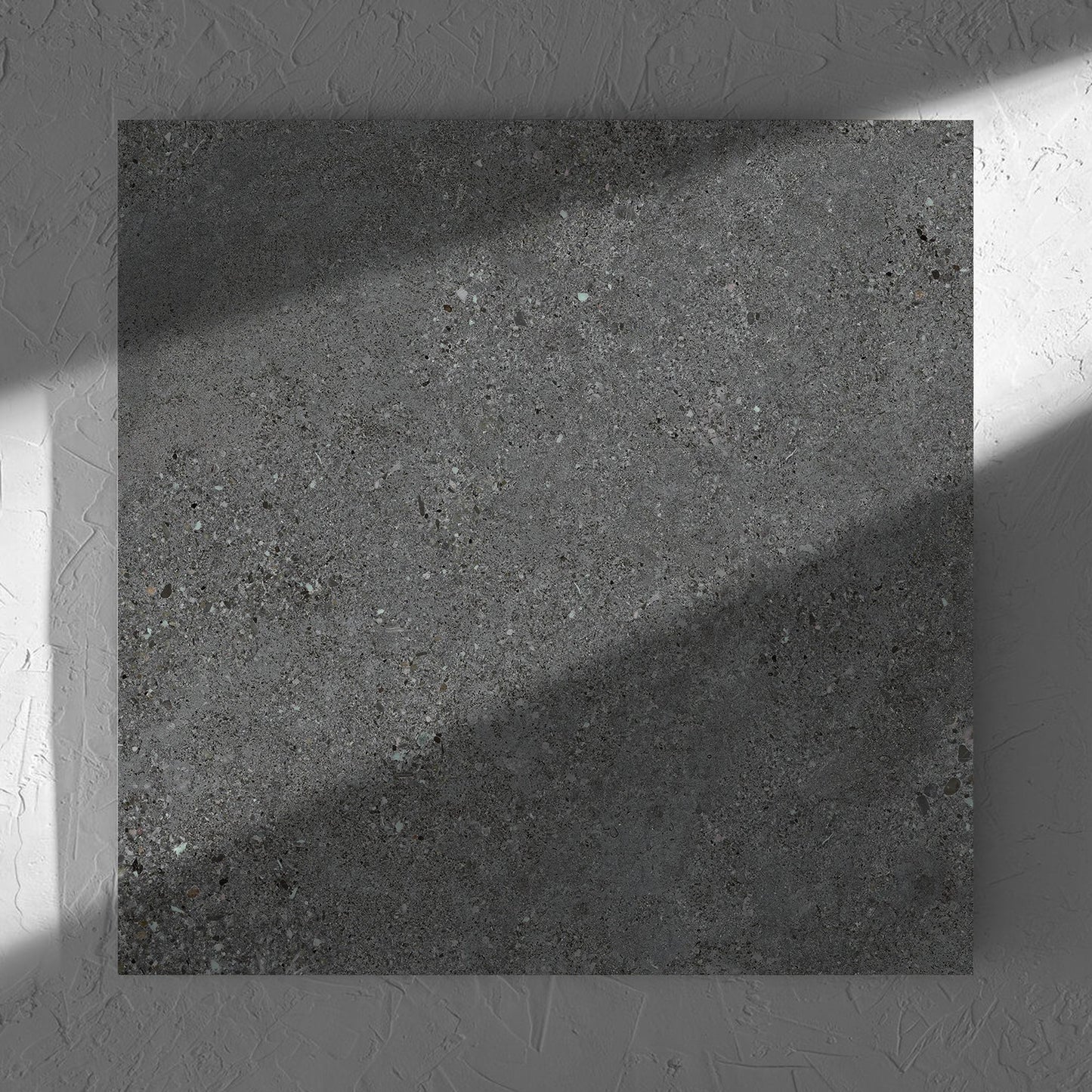 Terramix Charcoal Matt 600x600mm tile in soft natural window light, showing the matt surface