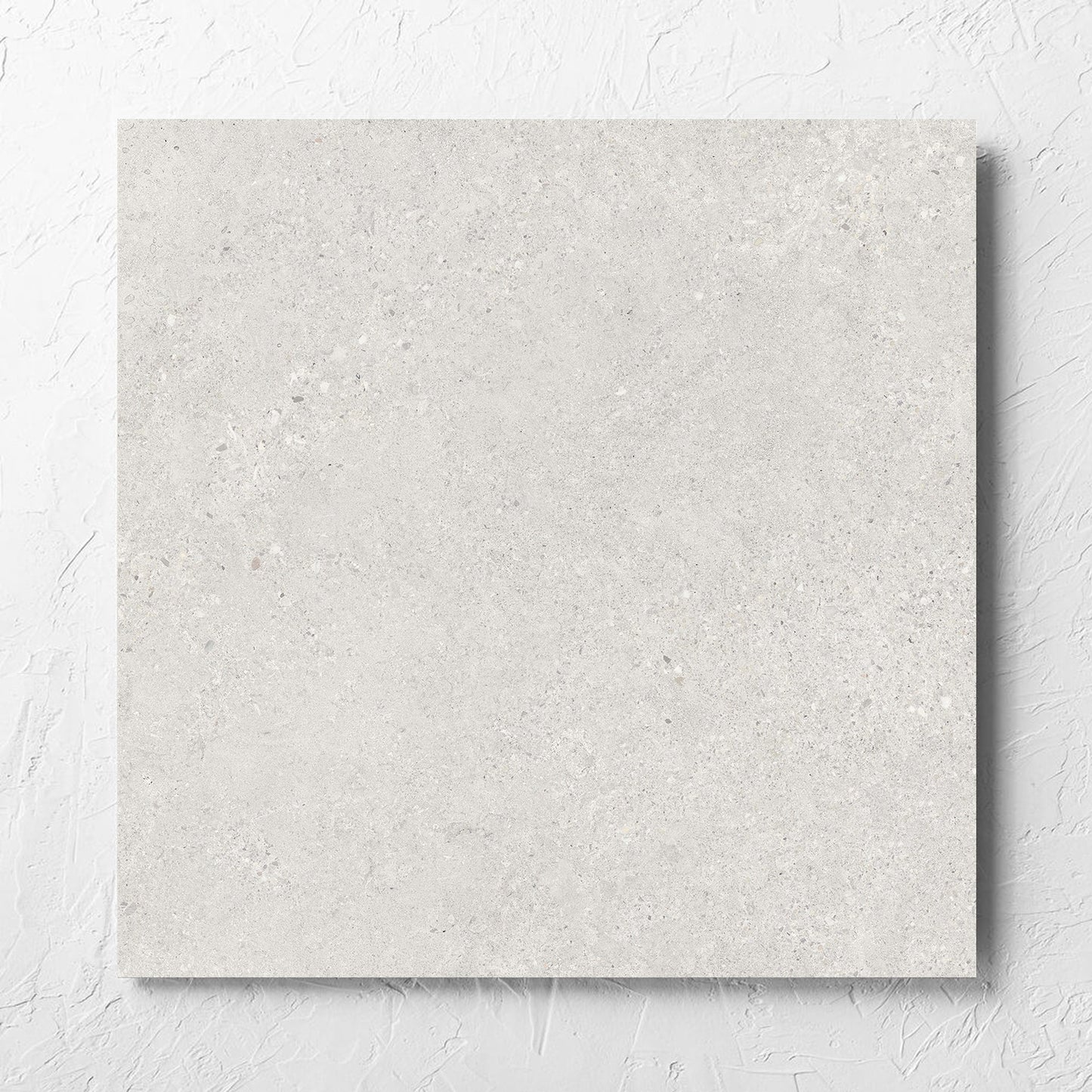 Terramix Cream Matt 600x600mm tile laid flat on a white rendered wall, showing the matt surface