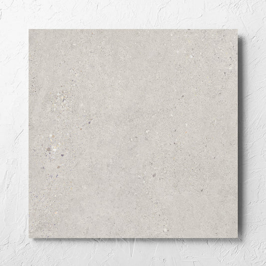 Terramix Sand Matt 600x600mm tile laid flat on a white rendered wall, showing the matt surface