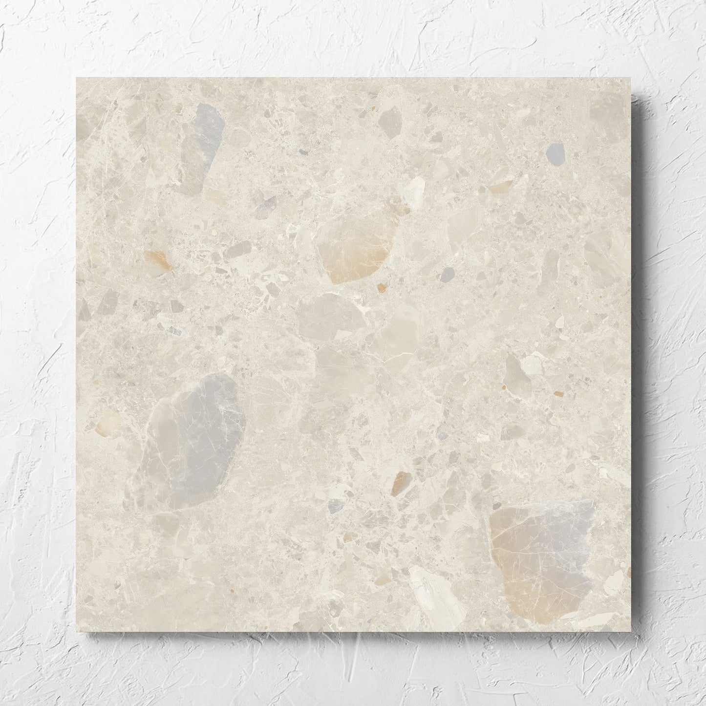 Terrazzo Rock Beige Matt 600x600mm tile laid flat on a white rendered wall, showing the tile surface