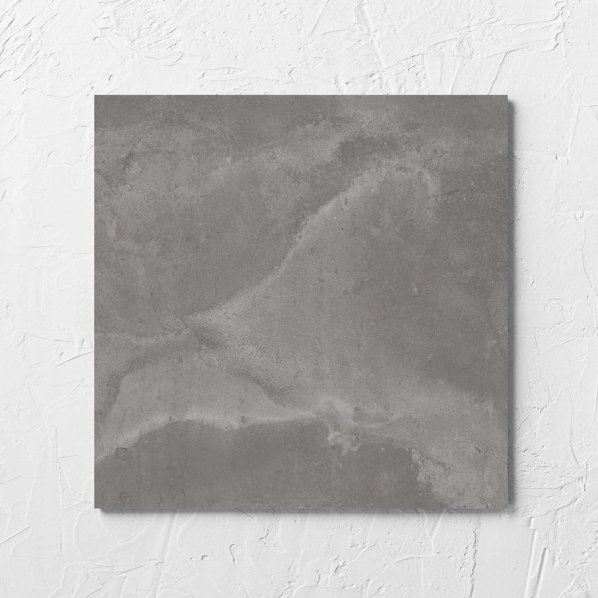 Thor Grey Matt 300x300mm tile laid flat on a white rendered wall, showing the matt surface