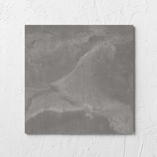 Thor Grey Matt 300x300mm tile laid flat on a white rendered wall, showing the matt surface