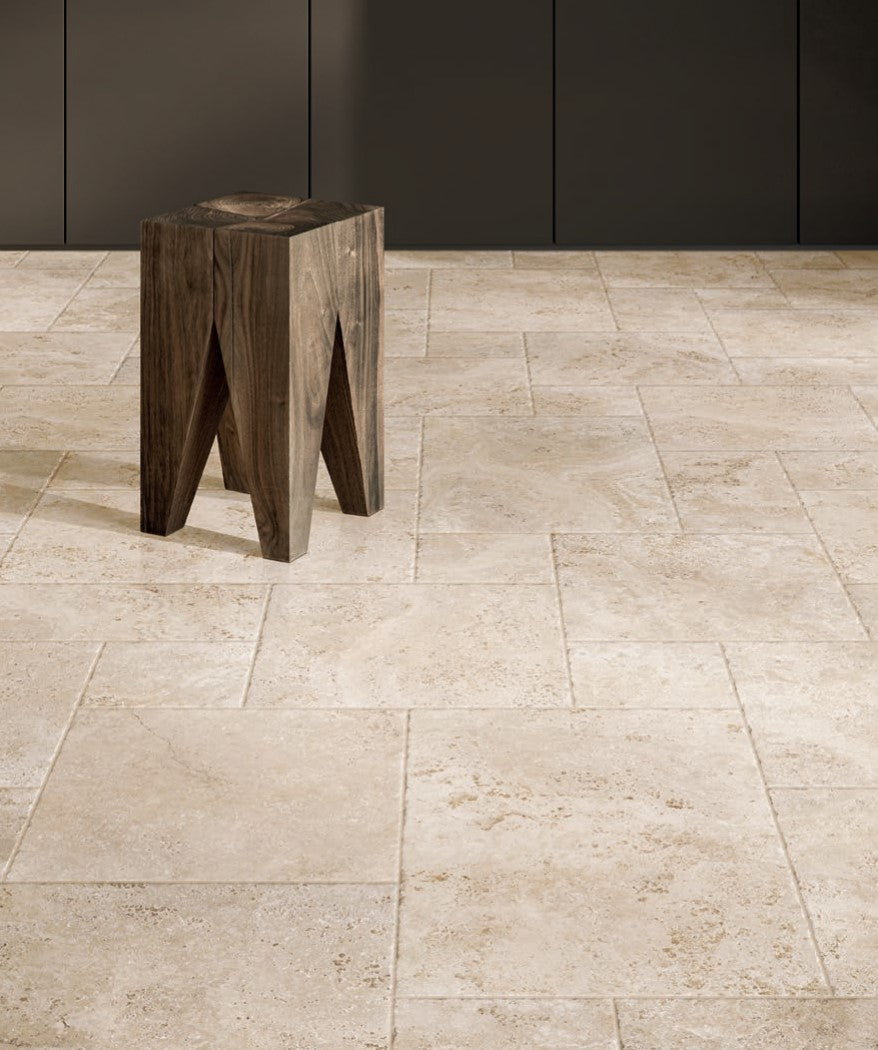 Tibur Beige Safe Modulo French Pattern 400x600mm installed as a living area floor with a rustic wooden stool against dark cabinetry.