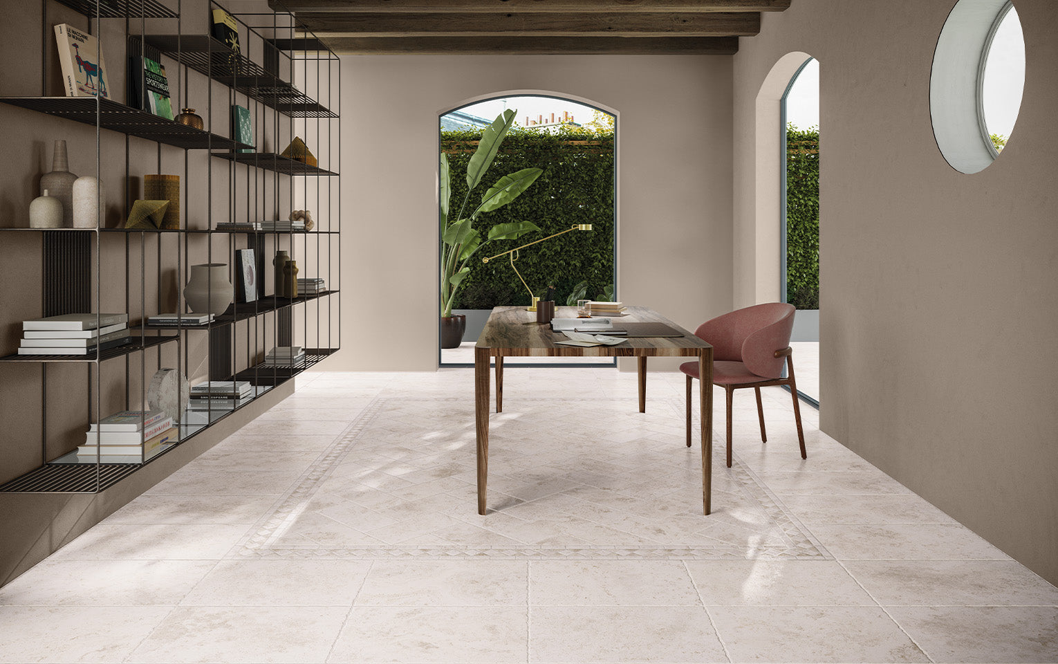 Tibur Bianco Modular 600x600mm porcelain floor tiles installed in a bright home office with a wooden desk, pink chair, and arched windows.