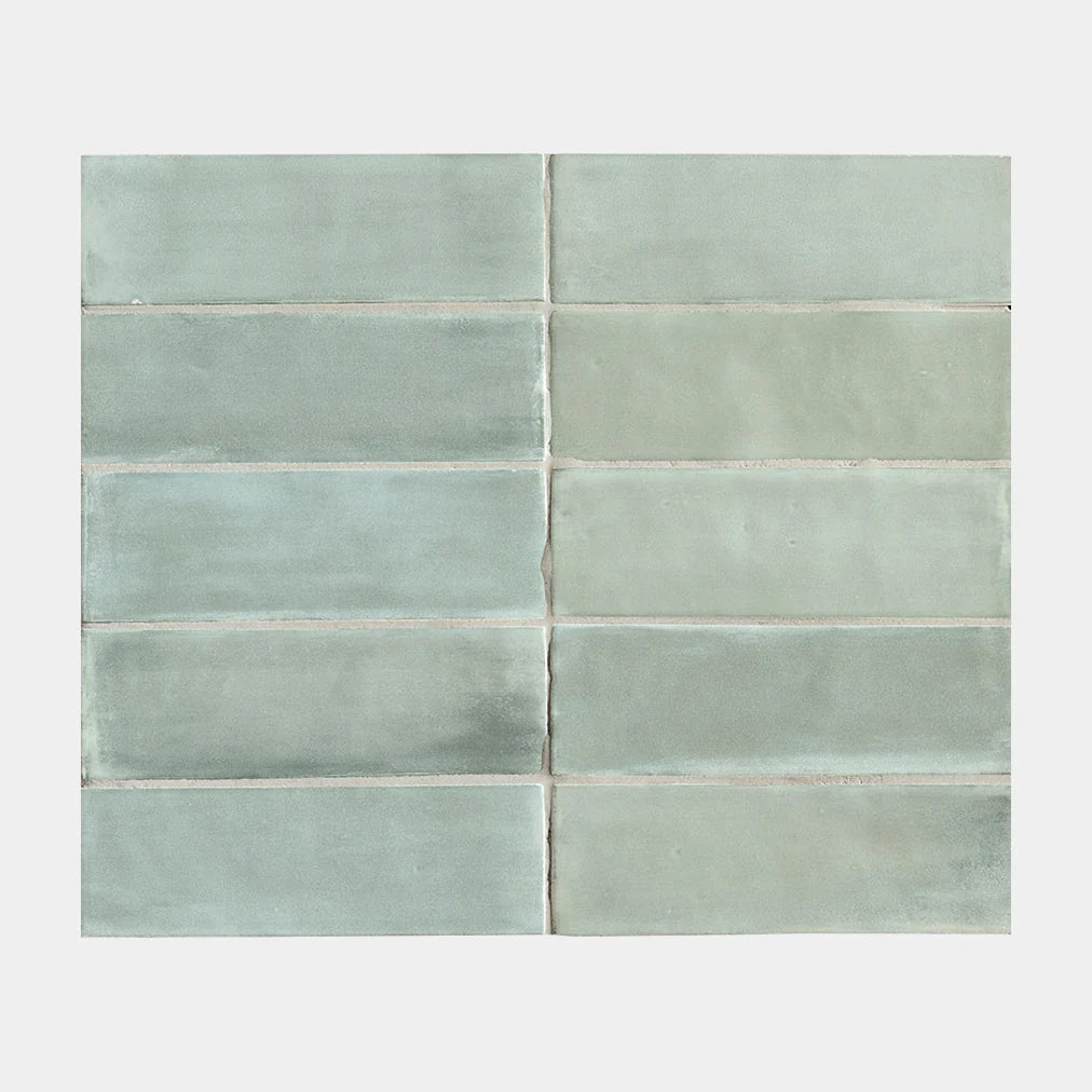 Flat-lay sample grid of Tint Sea Glass Matt Subway 52x160mm tiles showing soft aqua-green tones with subtle variation and matte glazed finish.