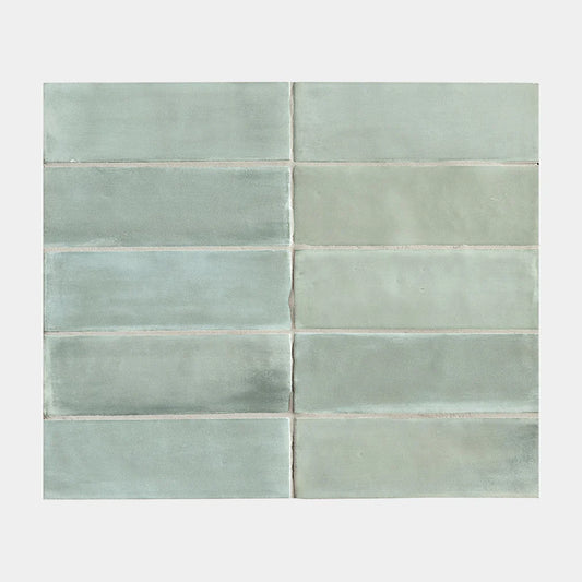 Flat-lay sample grid of Tint Sea Glass Matt Subway 52x160mm tiles showing soft aqua-green tones with subtle variation and matte glazed finish.