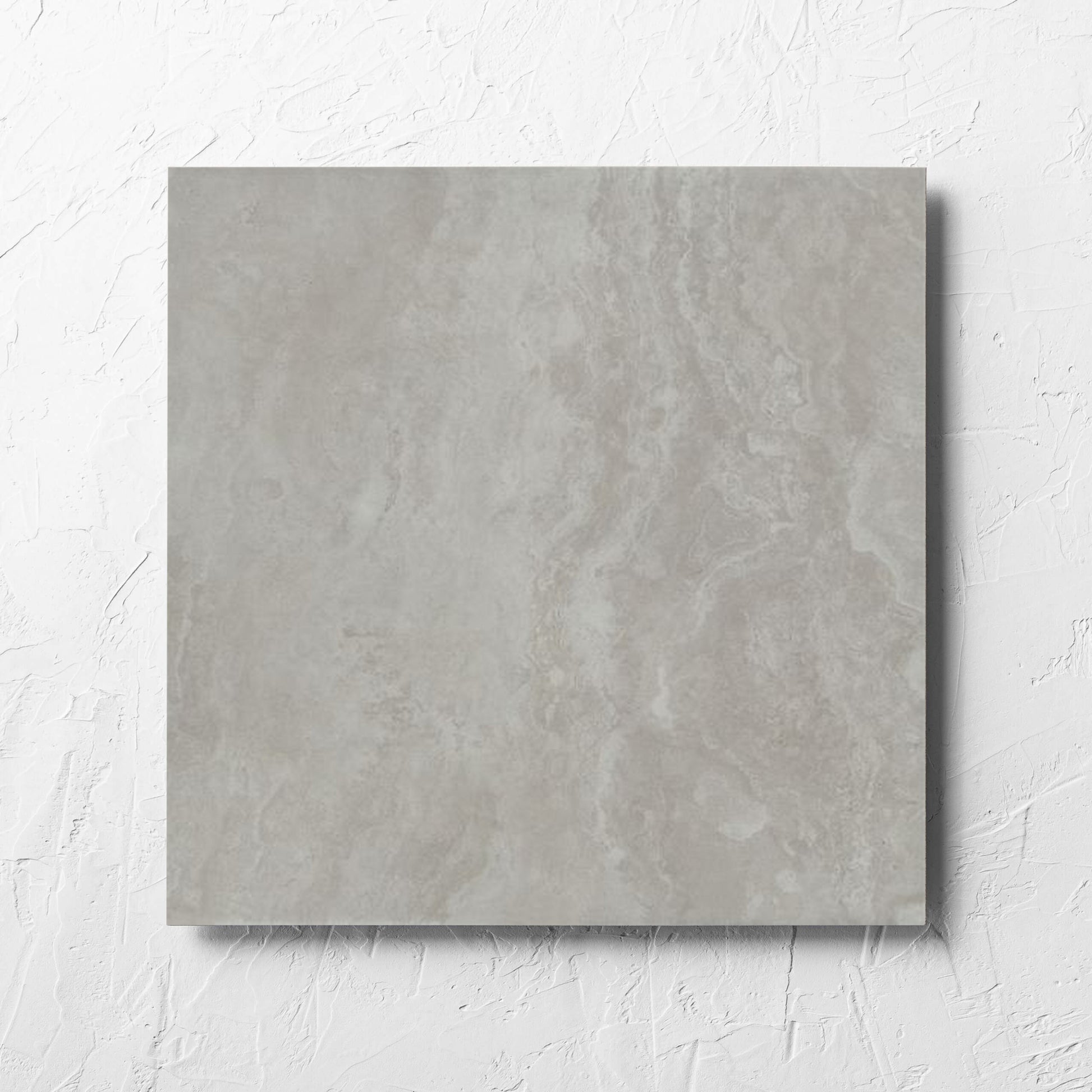 Tivoli Grey Grip 450x450mm tile laid flat on a white rendered wall, showing the matt surface