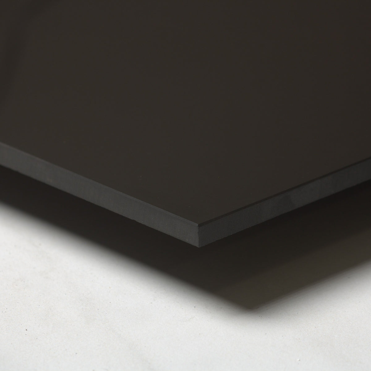 Unicolour Black Polished 600x600mm angle view showing the tile edge