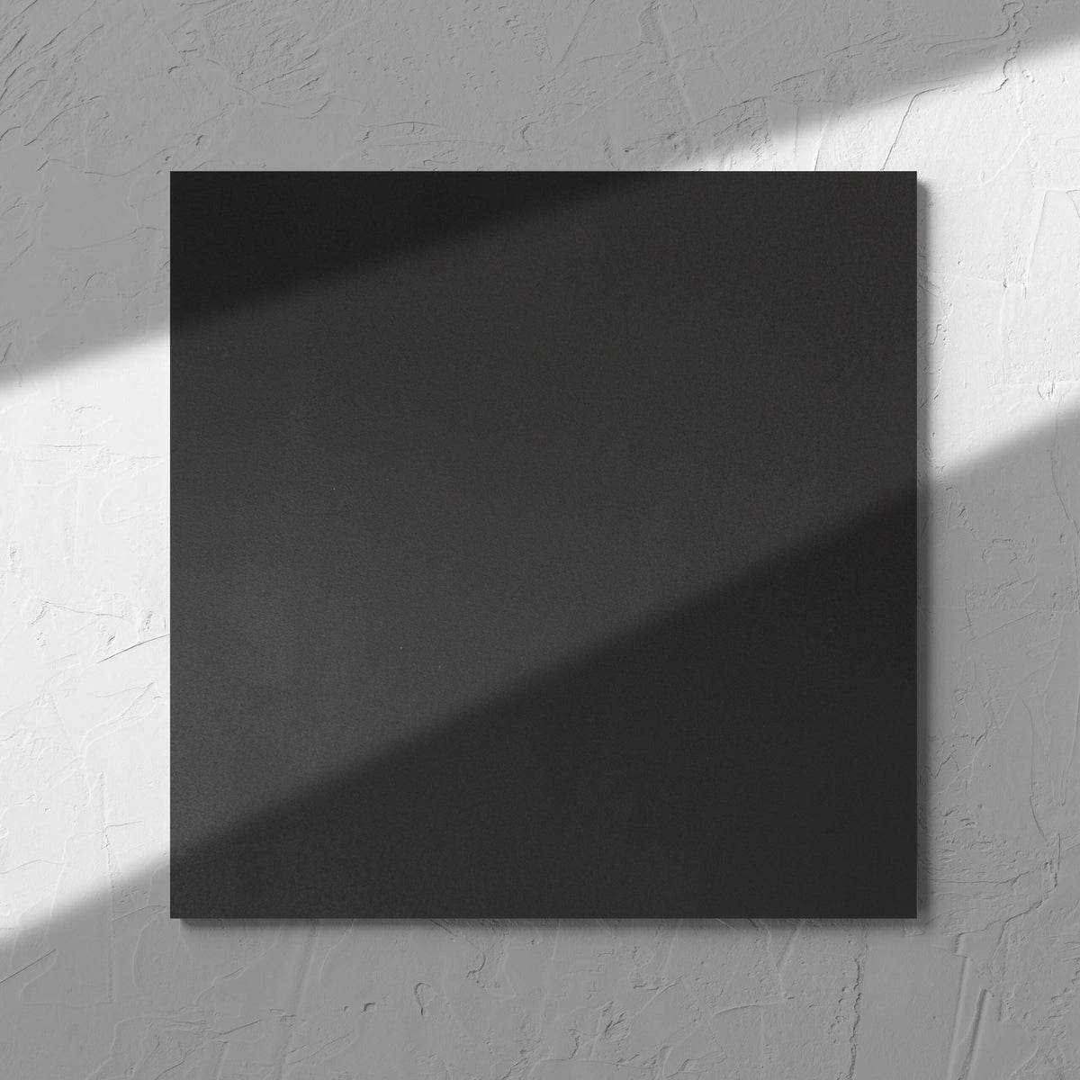 Unicolour Black R11 300x300mm tile in soft natural window light, showing the black r11 surface