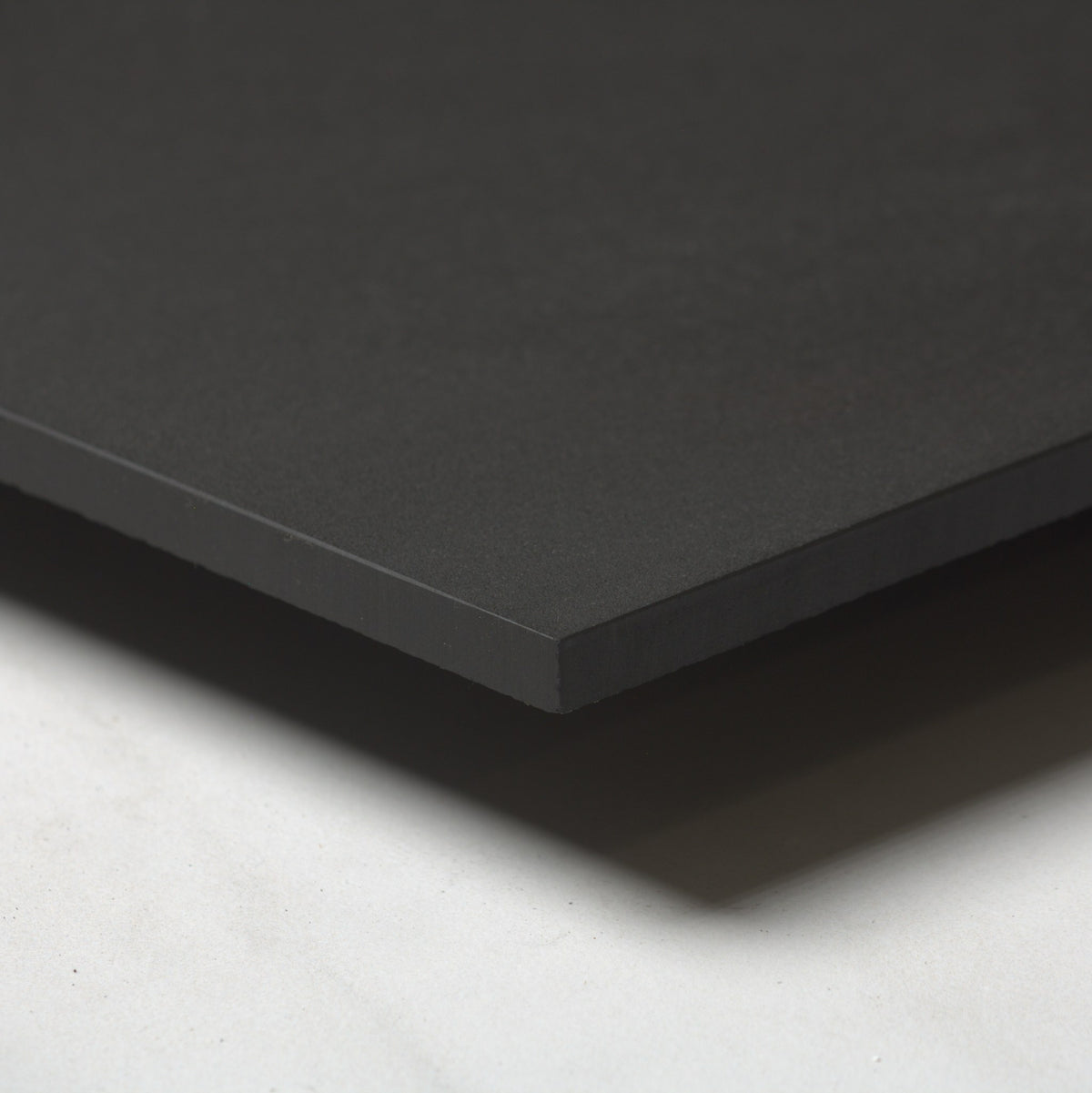 Unicolour Black R11 600x600mm angle view showing the tile edge