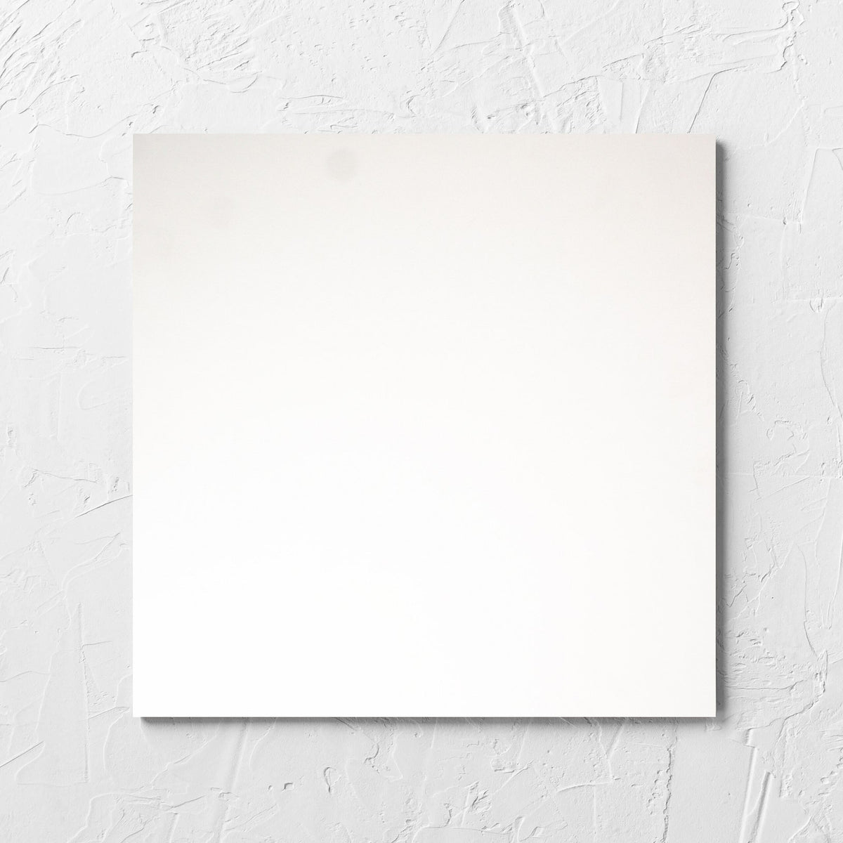 Unicolour Super White Matt 300x300mm tile laid flat on a white rendered wall, showing the super white matt surface