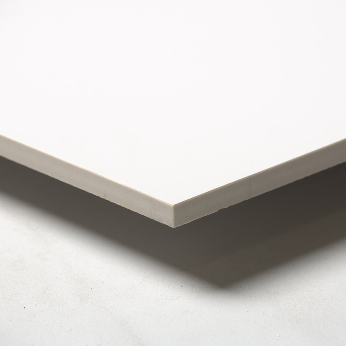 Unicolour Super White Matt 600x600mm angle view showing the tile edge
