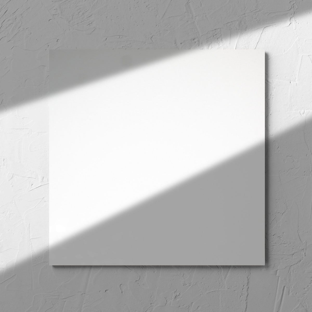 Unicolour White Polished 300x300mm tile in soft natural window light, showing the white polished surface