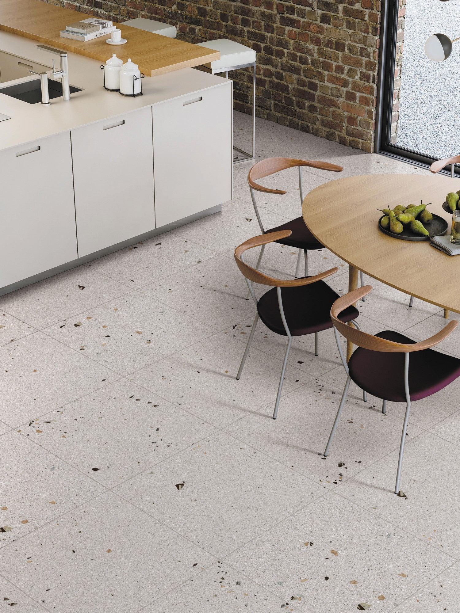 Vangogh Grey Matt Rectified 300x600mm terrazzo-effect floor tiles installed in a modern kitchen-dining space with round oak table and white cabinetry.
