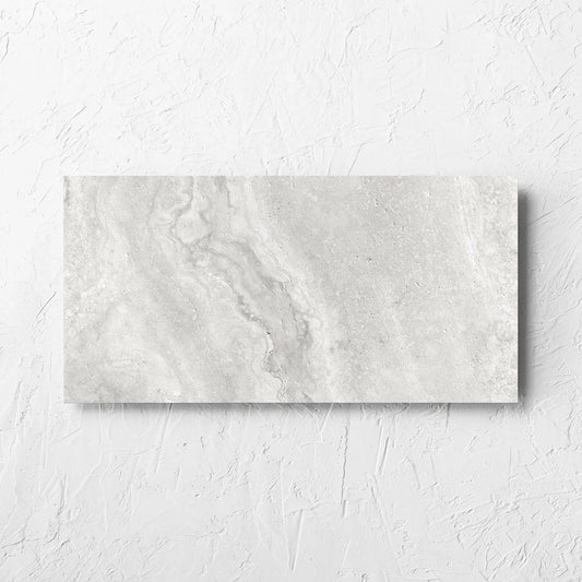 Vatican Silver Vein Cut Travertine 300x600mm tile laid flat on a white rendered wall, showing the matt surface