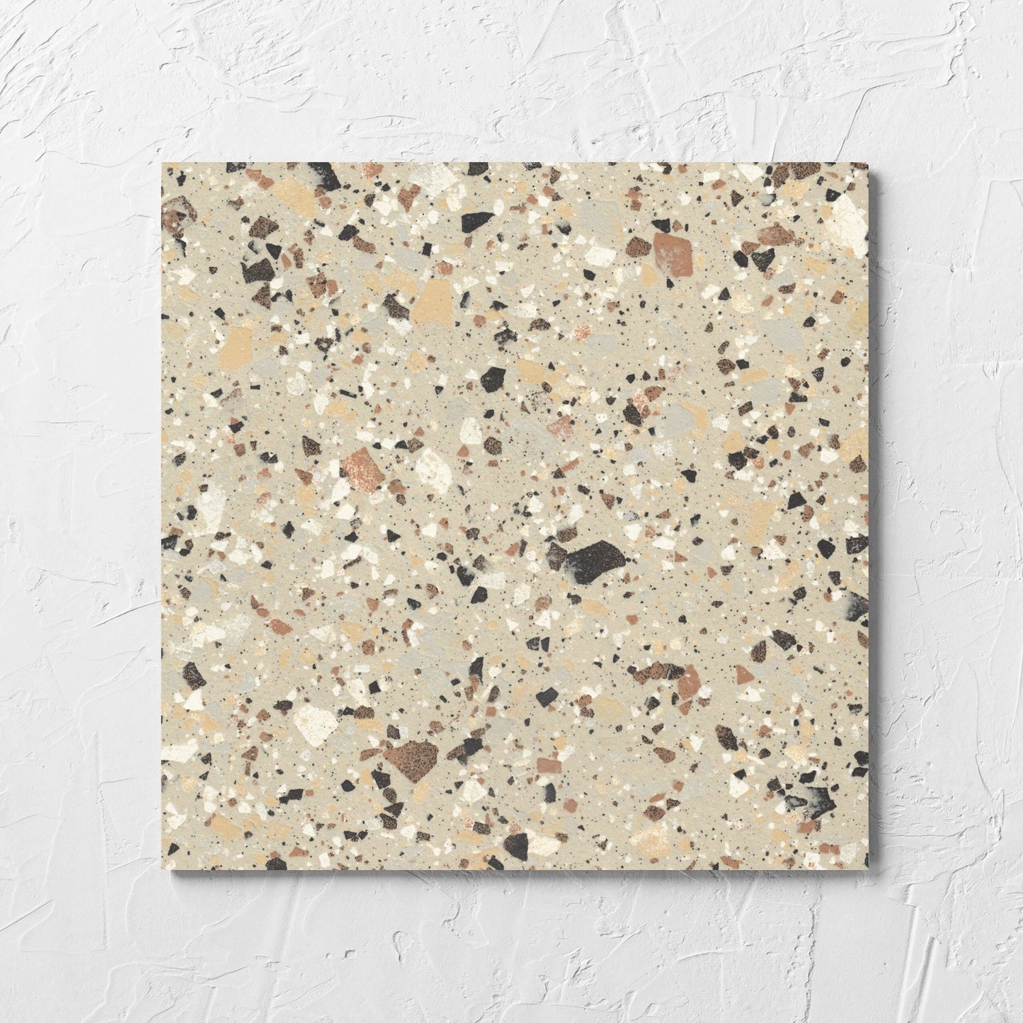 Venice Beige 300x300mm Matt Terrazzo Tile tile laid flat on a white rendered wall, showing the beige matt surface