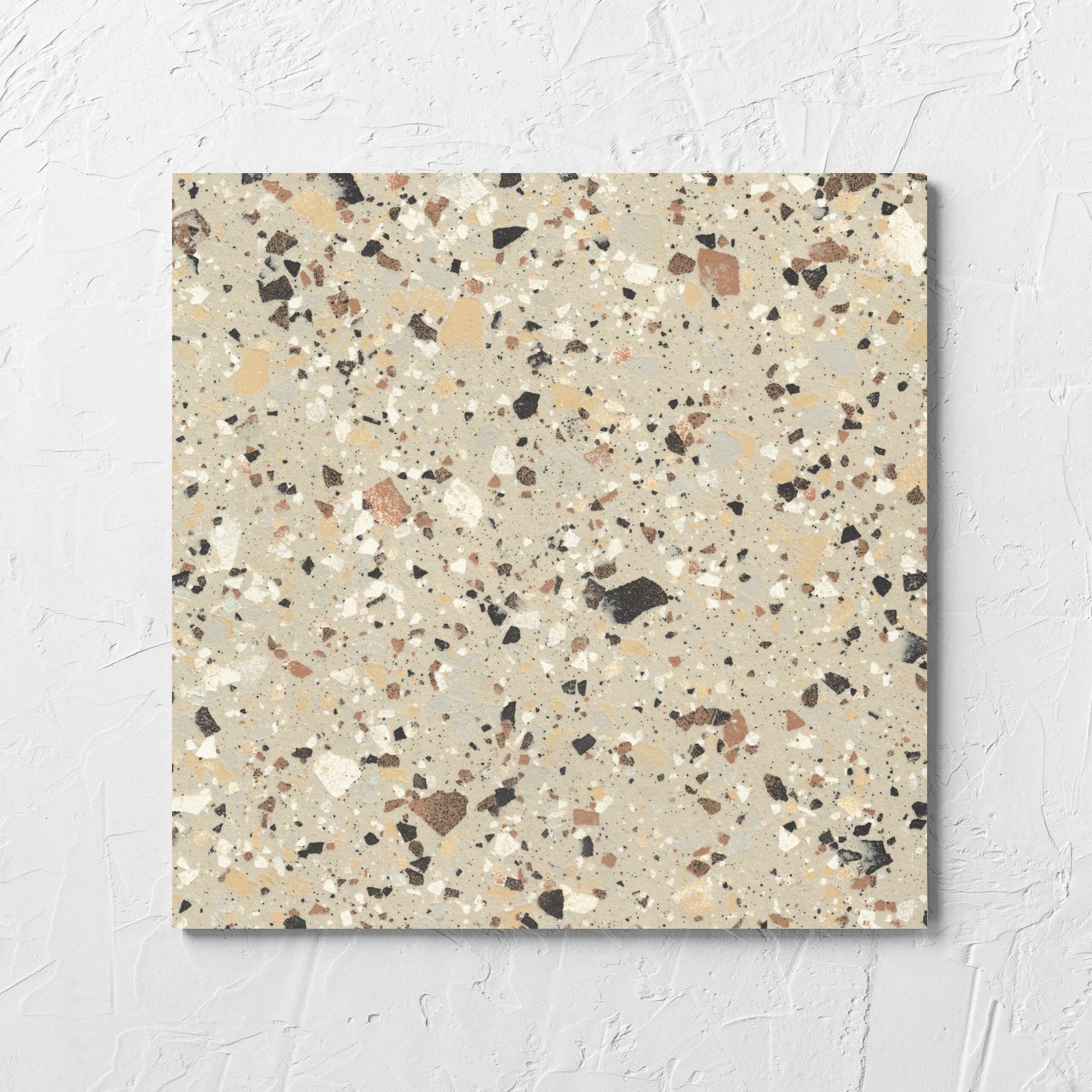Venice Beige 300x300mm Matt Terrazzo Tile tile laid flat on a white rendered wall, showing the beige matt surface