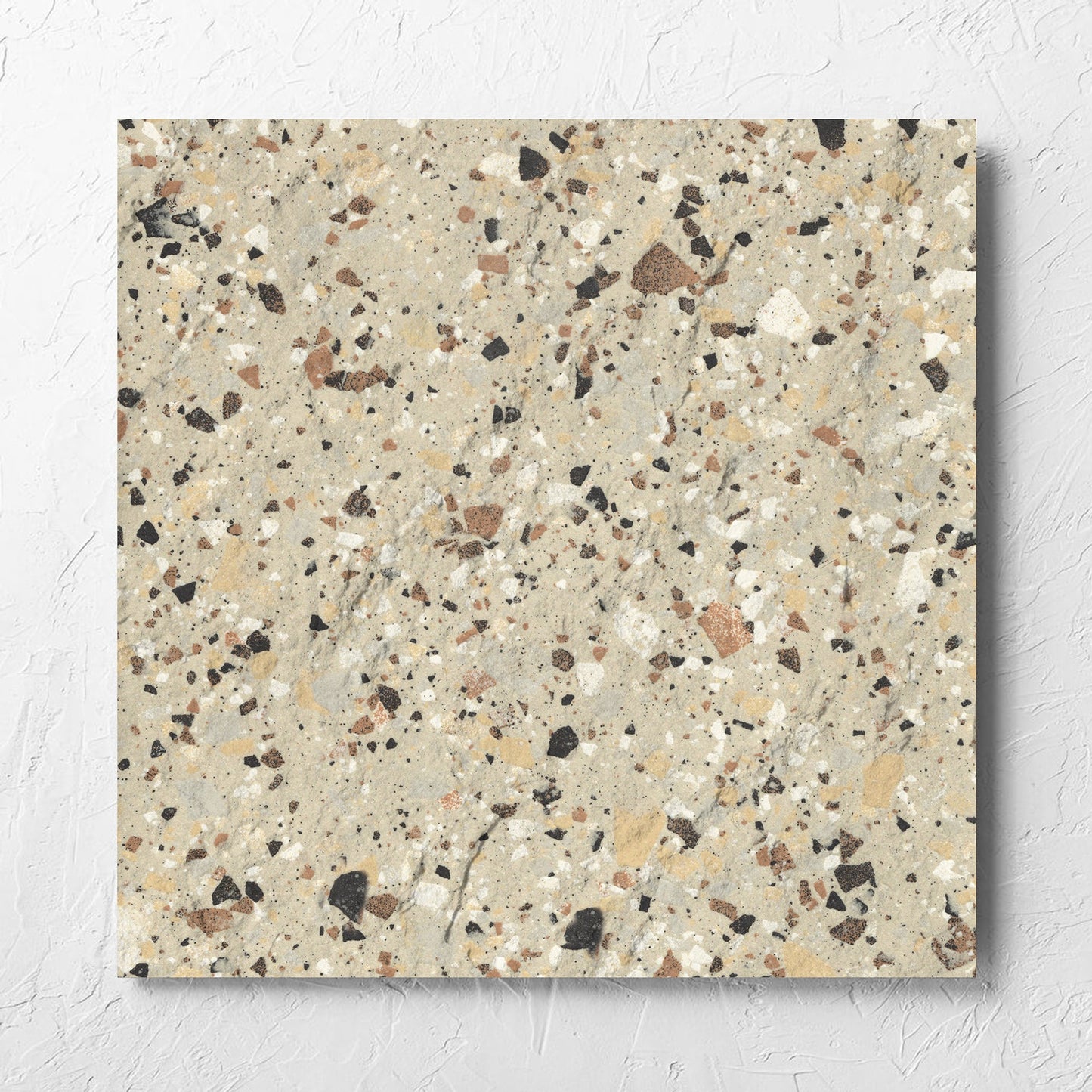 Venice Beige 600x600mm Matt Terrazzo External Tile laid flat on a white rendered wall, showing the beige matt surface