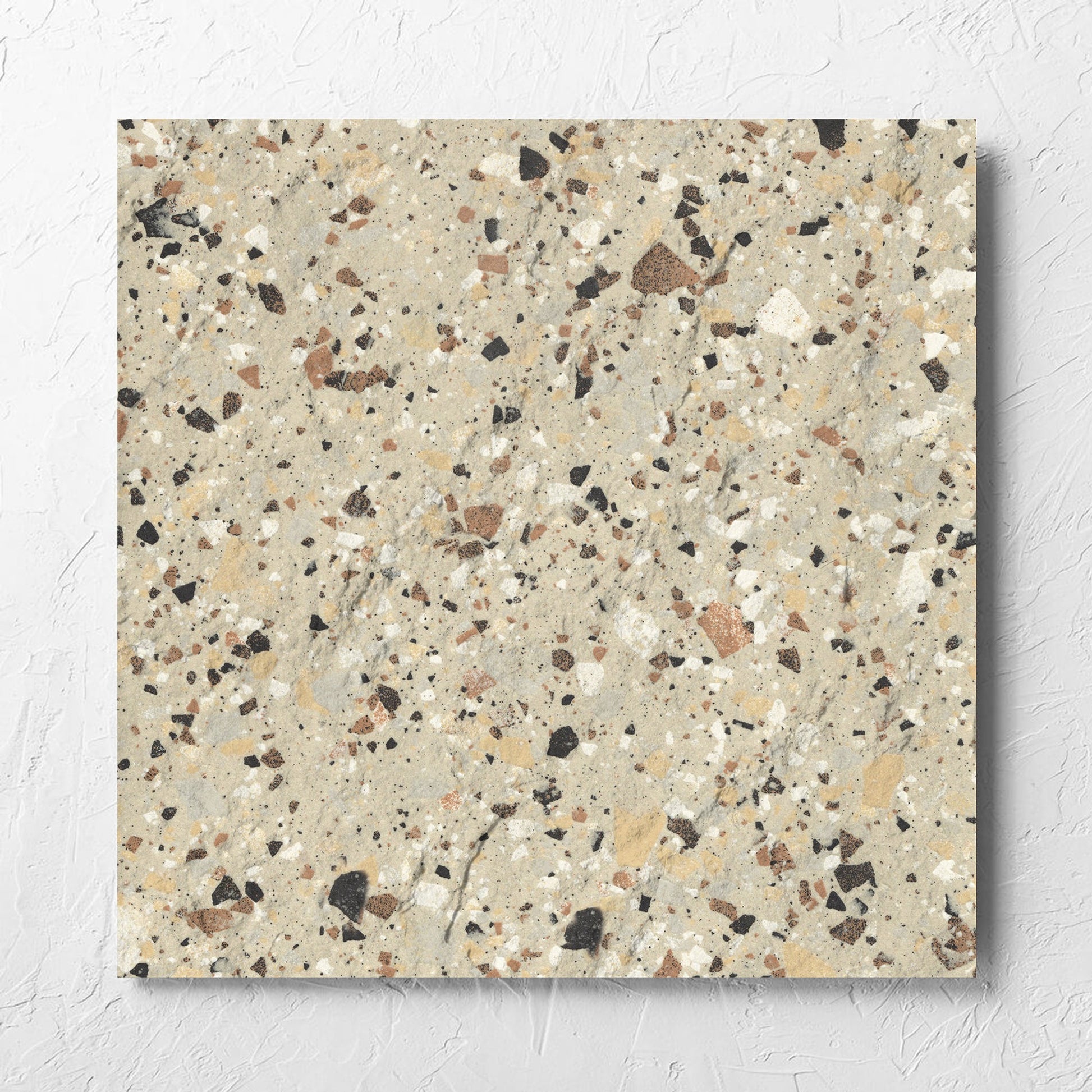 Venice Beige 600x600mm Matt Terrazzo External Tile laid flat on a white rendered wall, showing the beige matt surface