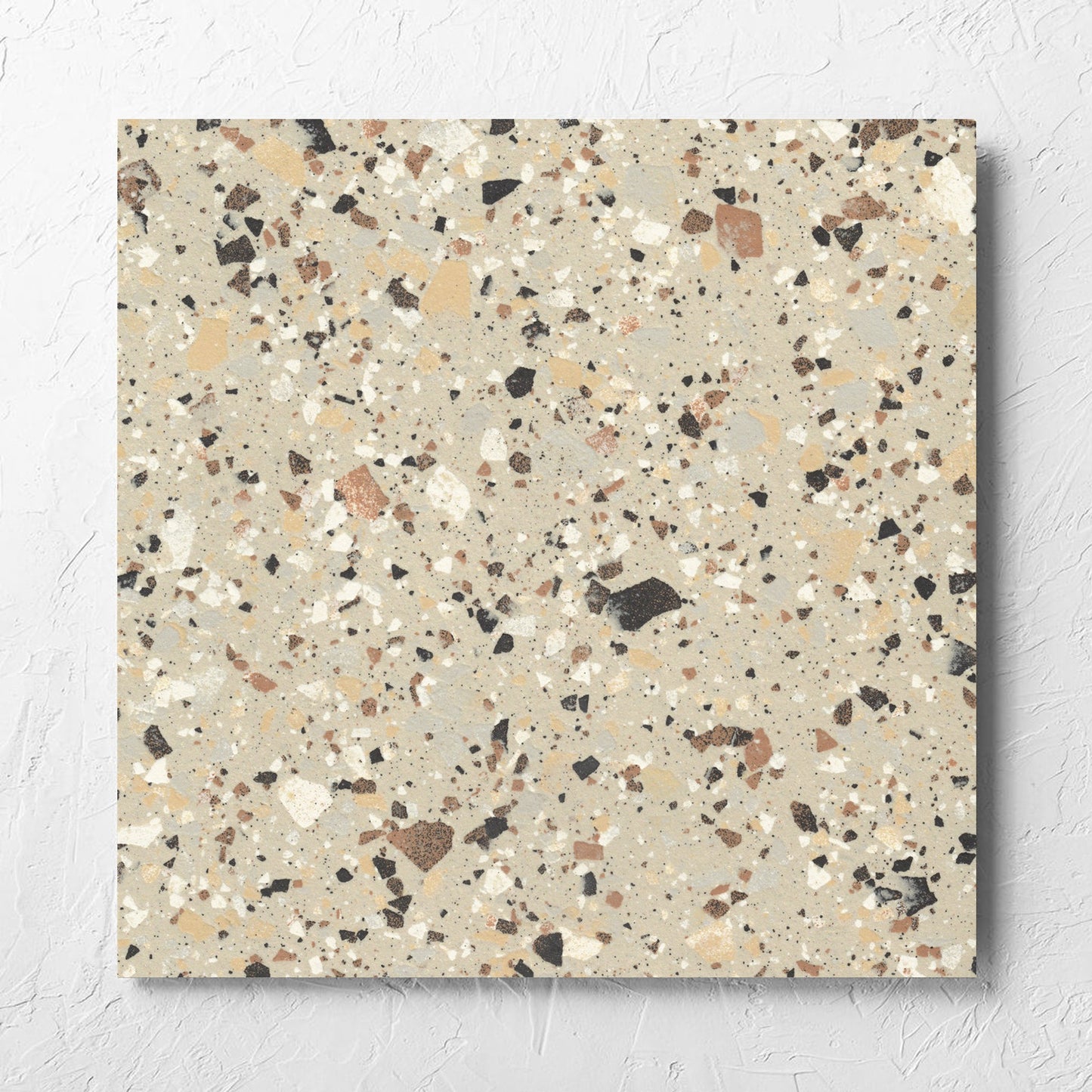 Venice Beige 600x600mm Matt Terrazzo Tile laid flat on a white rendered wall, showing the beige matt surface