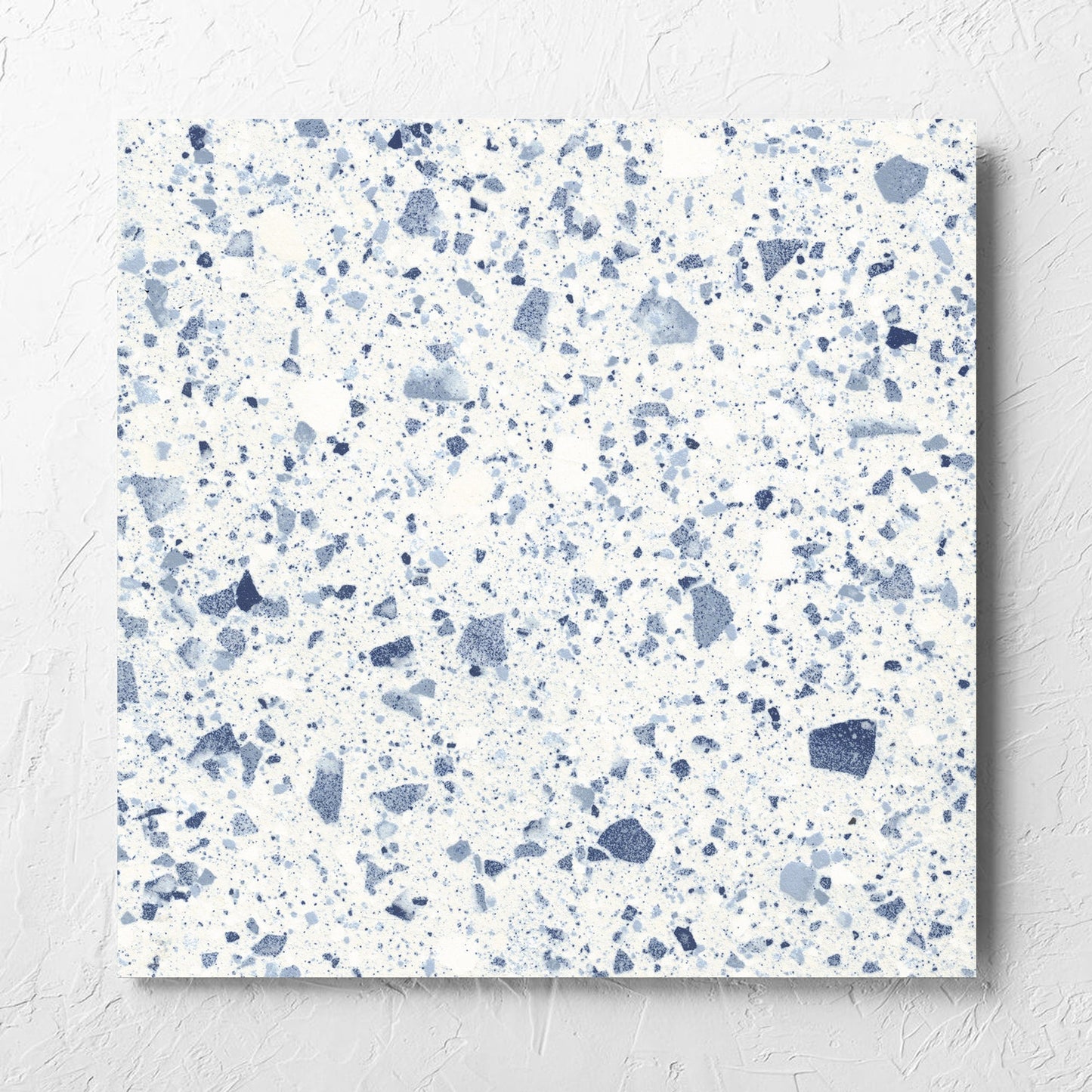 Venice Blue 600x600mm Matt Terrazzo Tile laid flat on a white rendered wall, showing the blue matt surface