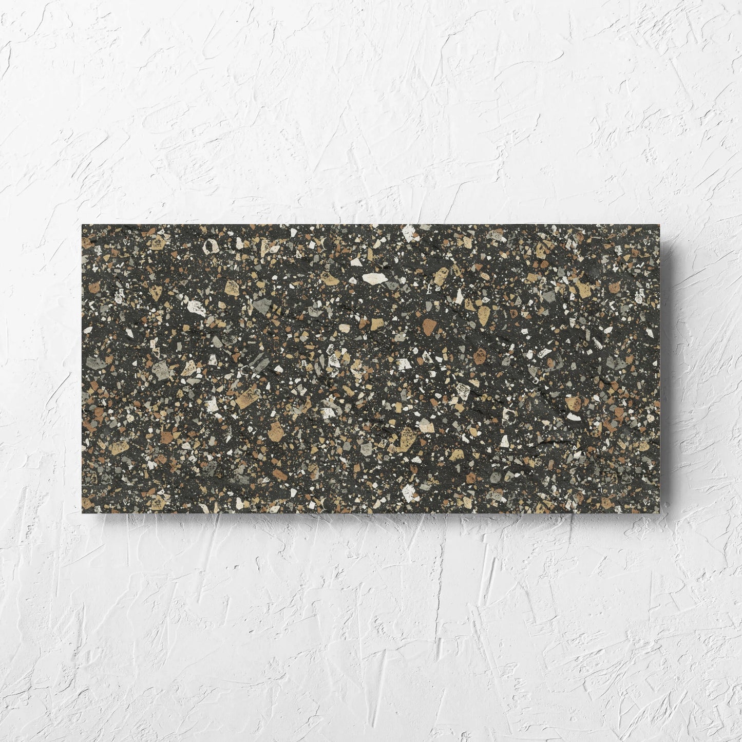 Venice Earth 300x600mm Matt Terrazzo External Tile laid flat on a white rendered wall, showing the earth matt surface