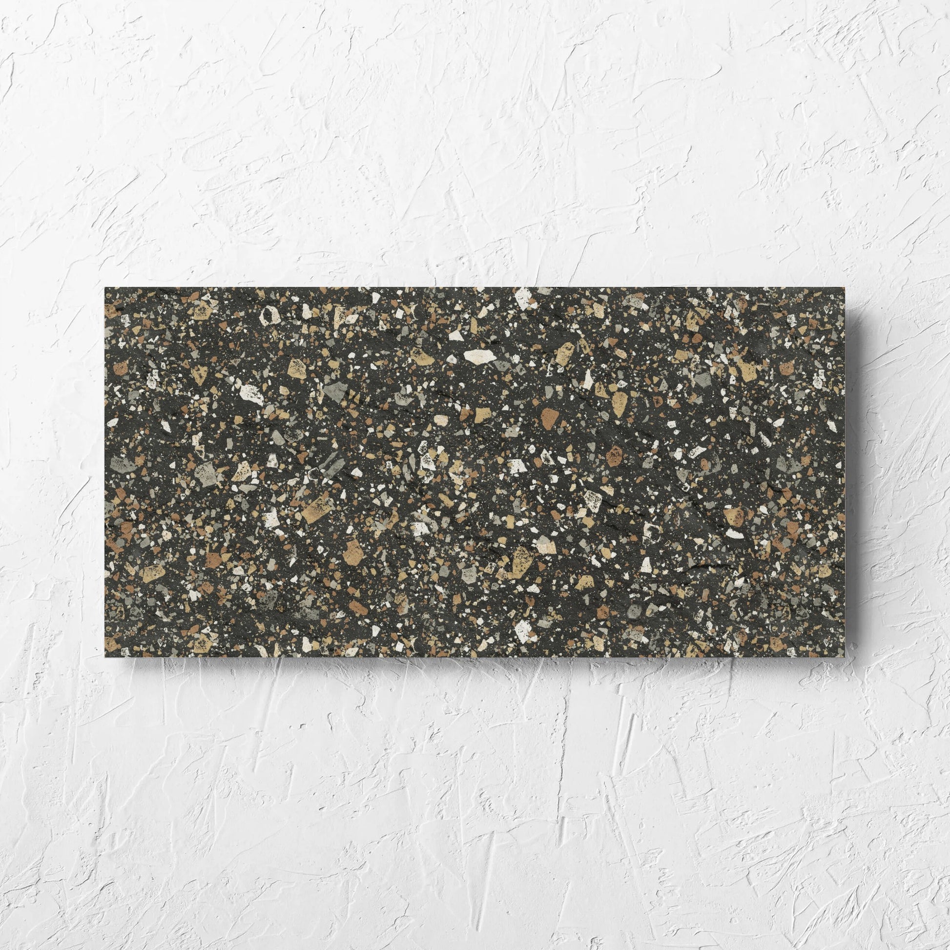 Venice Earth 300x600mm Matt Terrazzo External Tile laid flat on a white rendered wall, showing the earth matt surface