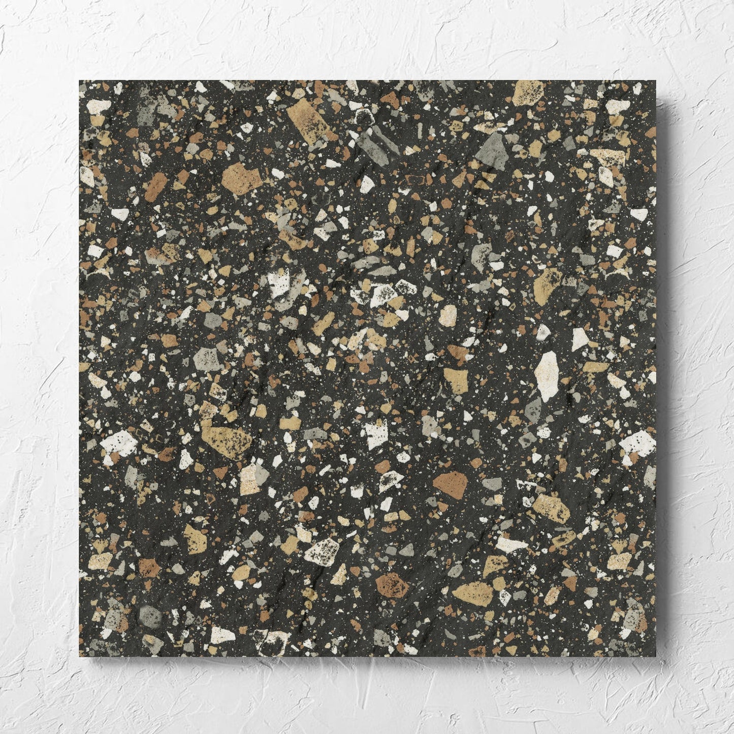 Venice Earth 600x600mm Matt Terrazzo External Tile laid flat on a white rendered wall, showing the earth matt surface