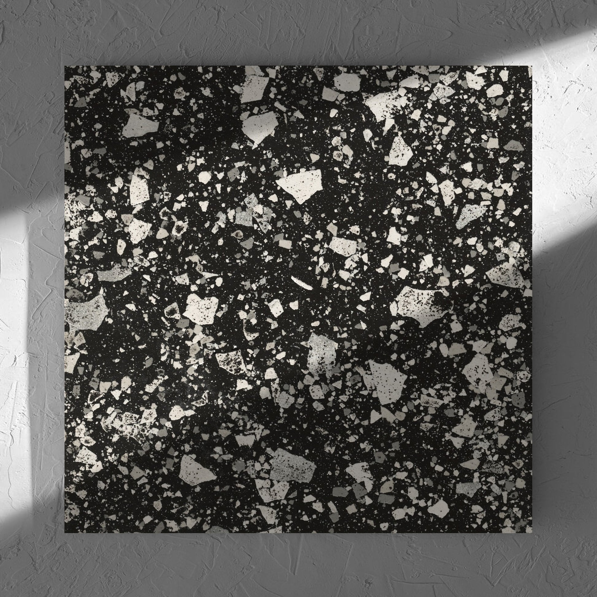 Venice Graphite 600x600mm Matt Terrazzo Tile in soft natural window light, showing the graphite matt surface