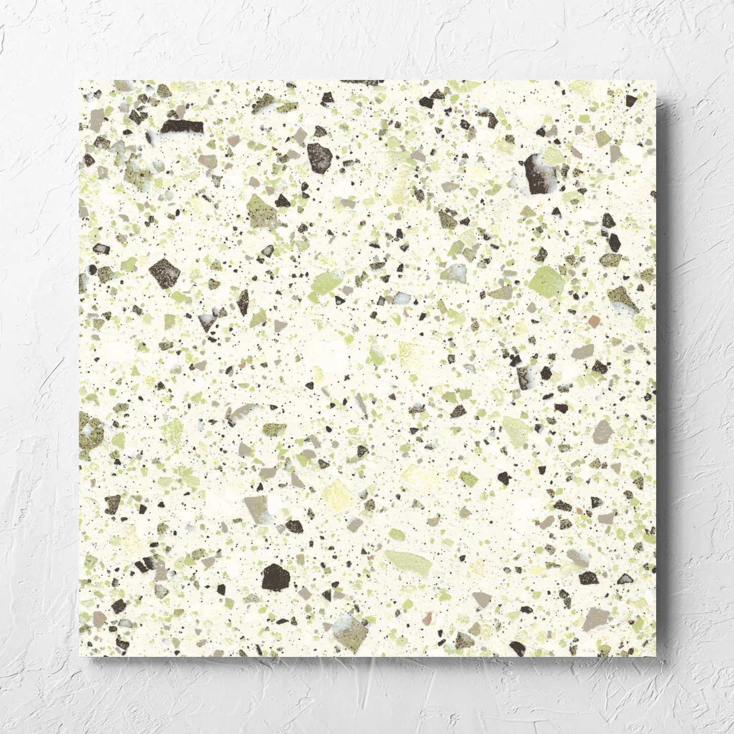 Venice Green 600x600mm Matt Terrazzo Tile laid flat on a white rendered wall, showing the green matt surface