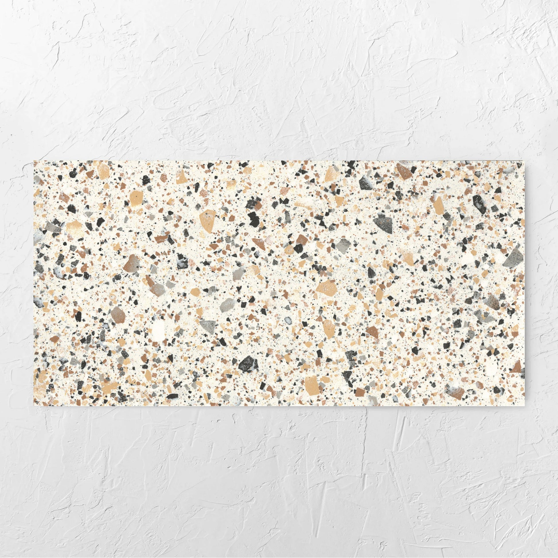 Venice Ivory 600x1200mm Matt Terrazzo Tile laid flat on a white rendered wall, showing the ivory matt surface