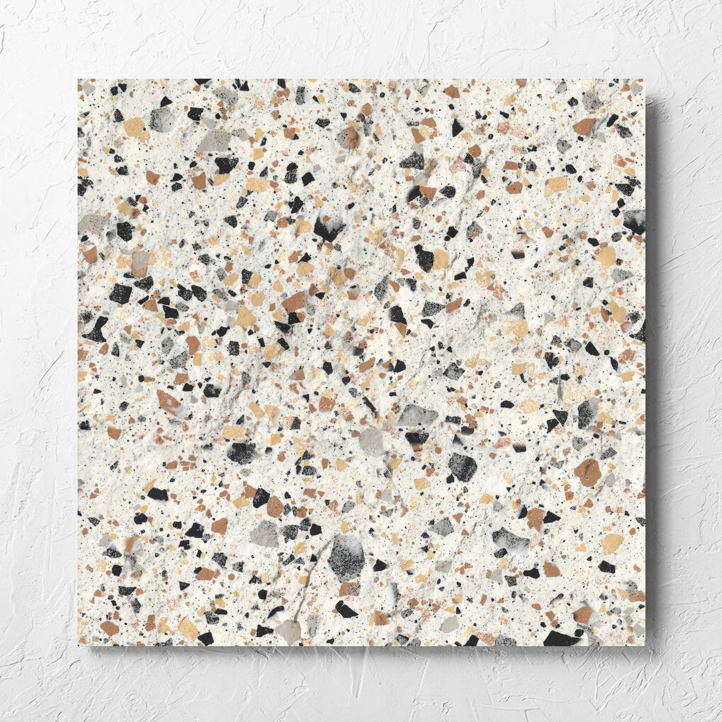 Venice Ivory 600x600mm Matt Terrazzo External Tile laid flat on a white rendered wall, showing the ivory matt surface
