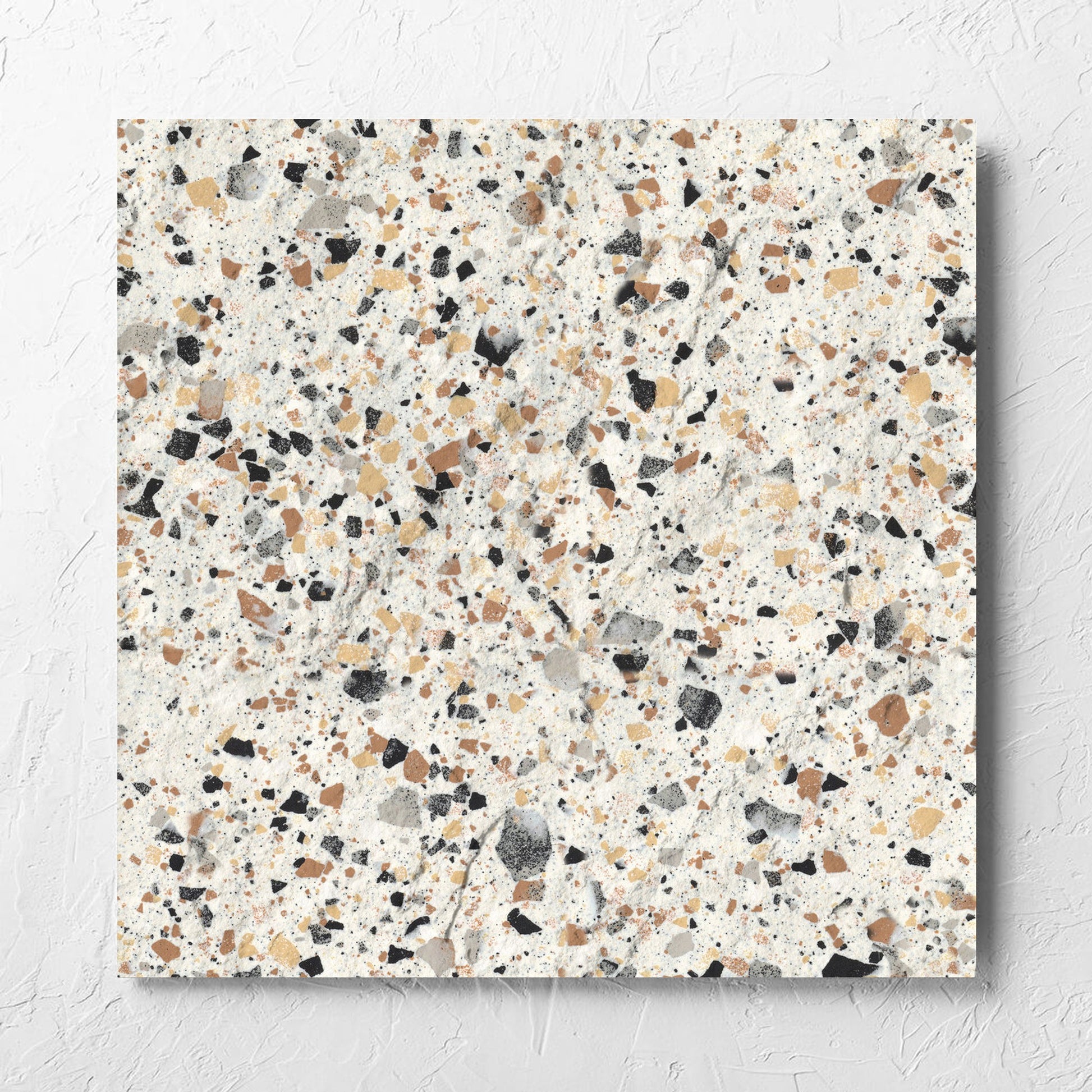 Venice Ivory 600x600mm Matt Terrazzo External Tile laid flat on a white rendered wall, showing the ivory matt surface