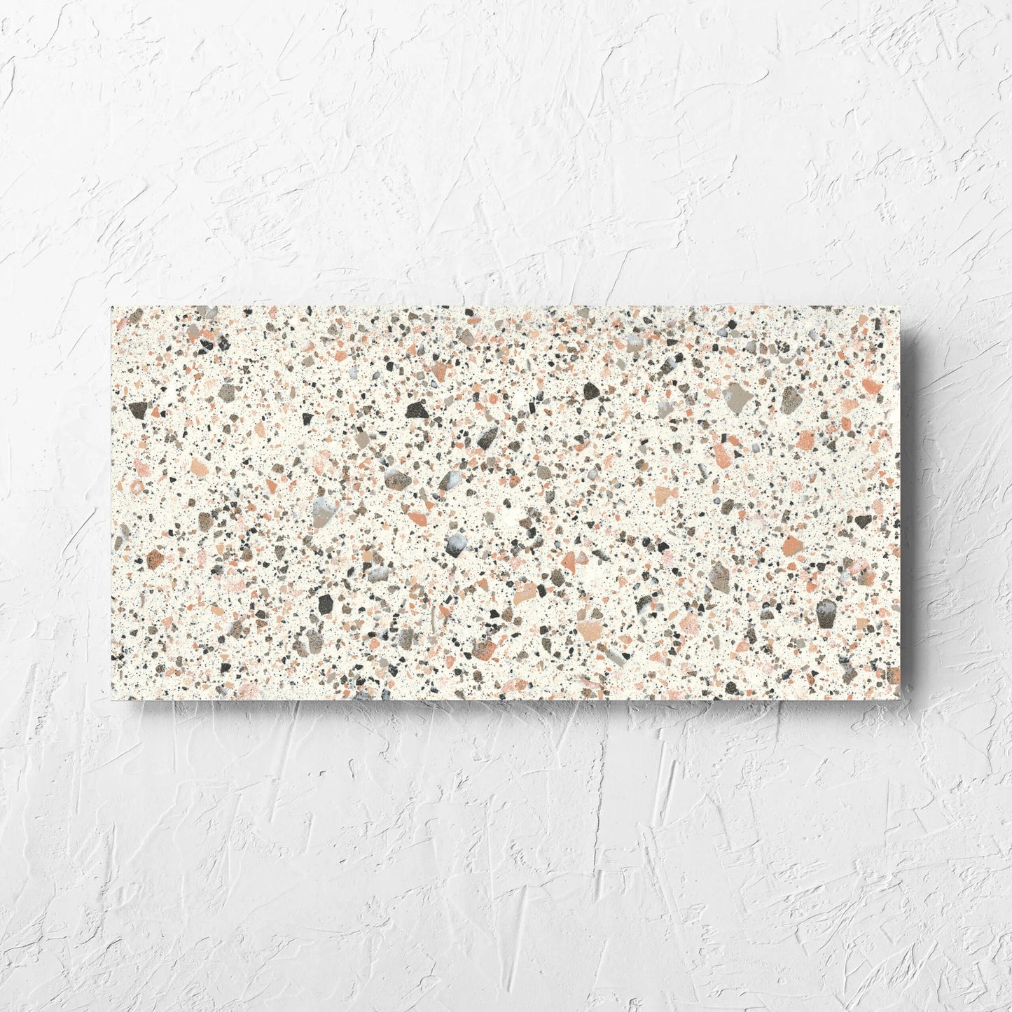Venice Pink 300x600mm Matt Terrazzo Tile laid flat on a white rendered wall, showing the pink matt surface