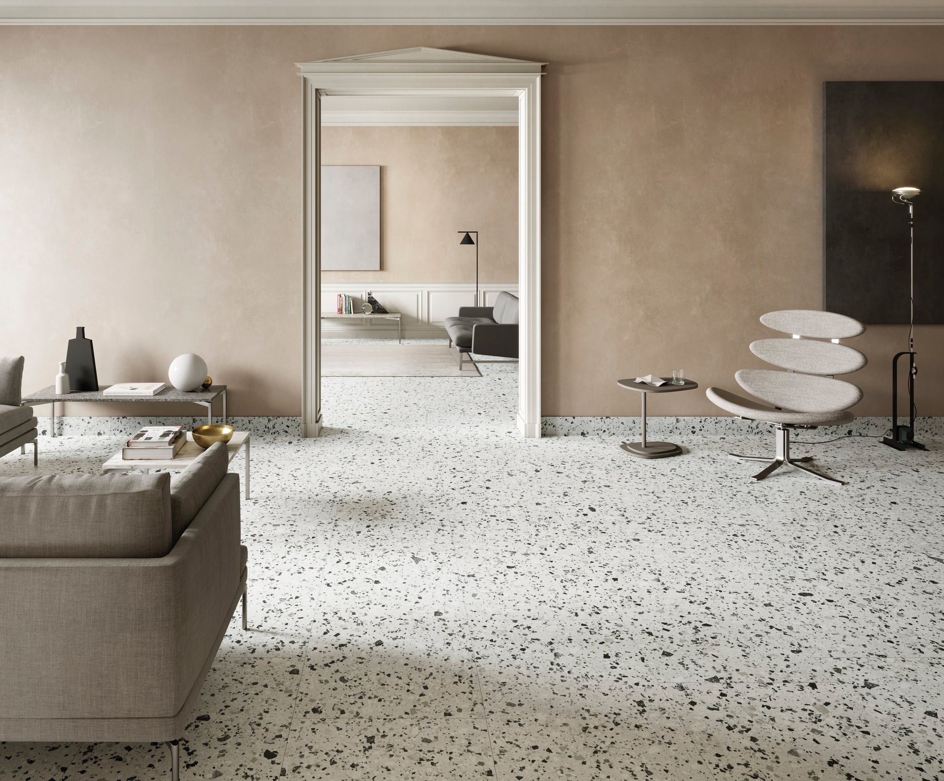 Venice Silver 300x300mm Matt Terrazzo Tile installed across a spacious living room floor with a modern lounge chair, sofa, and elegant doorway.
