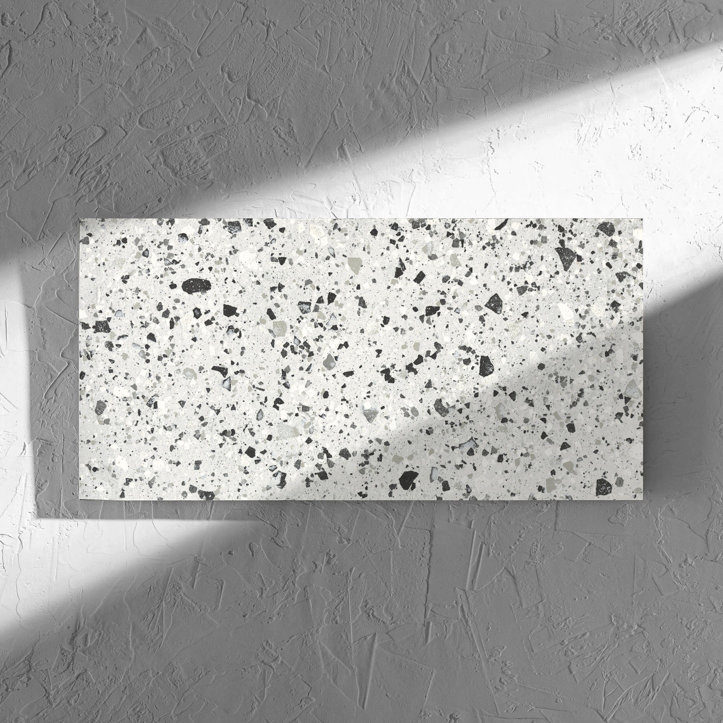 Venice Silver 300x600mm Matt Terrazzo Tile in soft natural window light, showing the silver matt surface